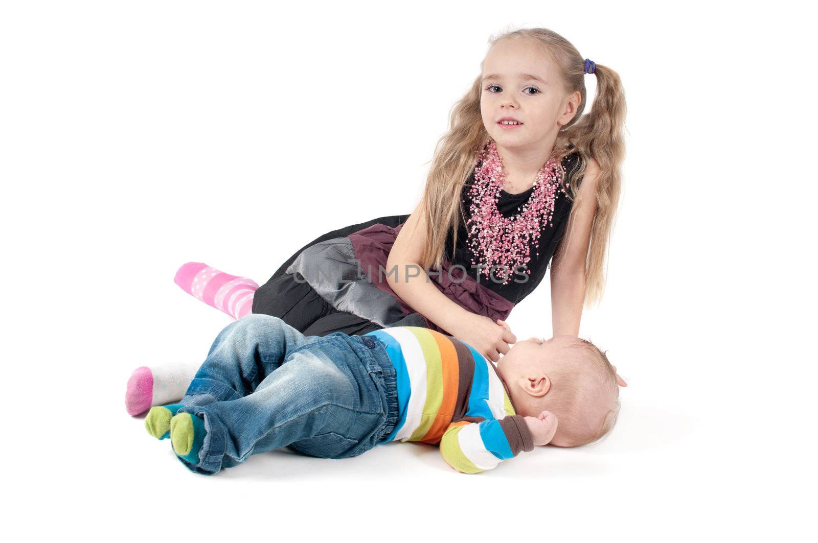 Shot of newborn baby with sister lying on white background