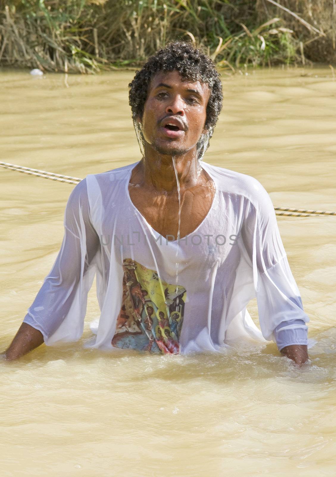 QASER EL YAHUD , ISRAEL - JAN 19 : Unidentified Ethiopian orthodox Christian man  participates in the baptising ritual during the epiphany at Qaser el yahud , Israel in January 19 2012