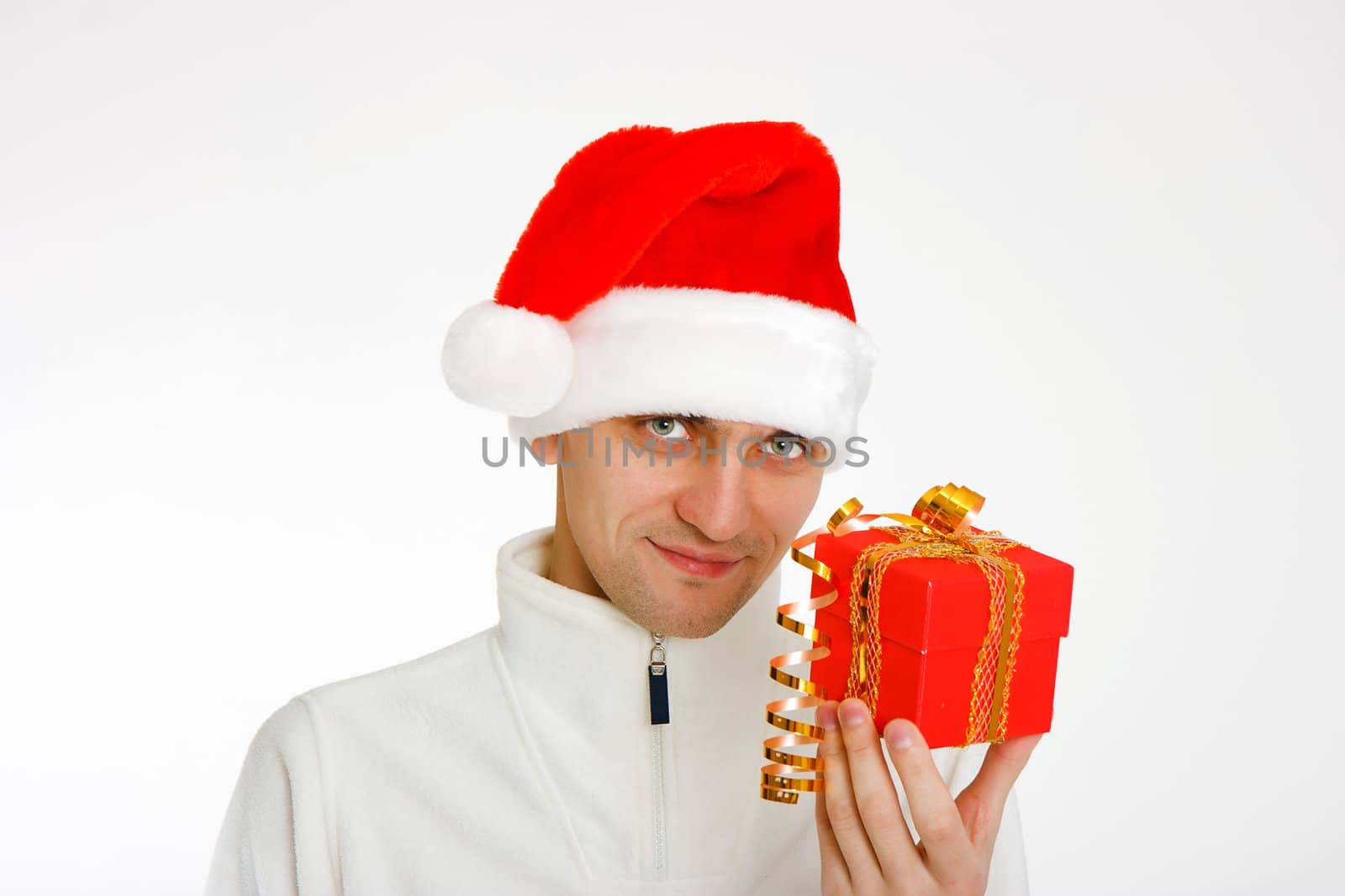 young man in a Santa hat holding a red Christmas gift
