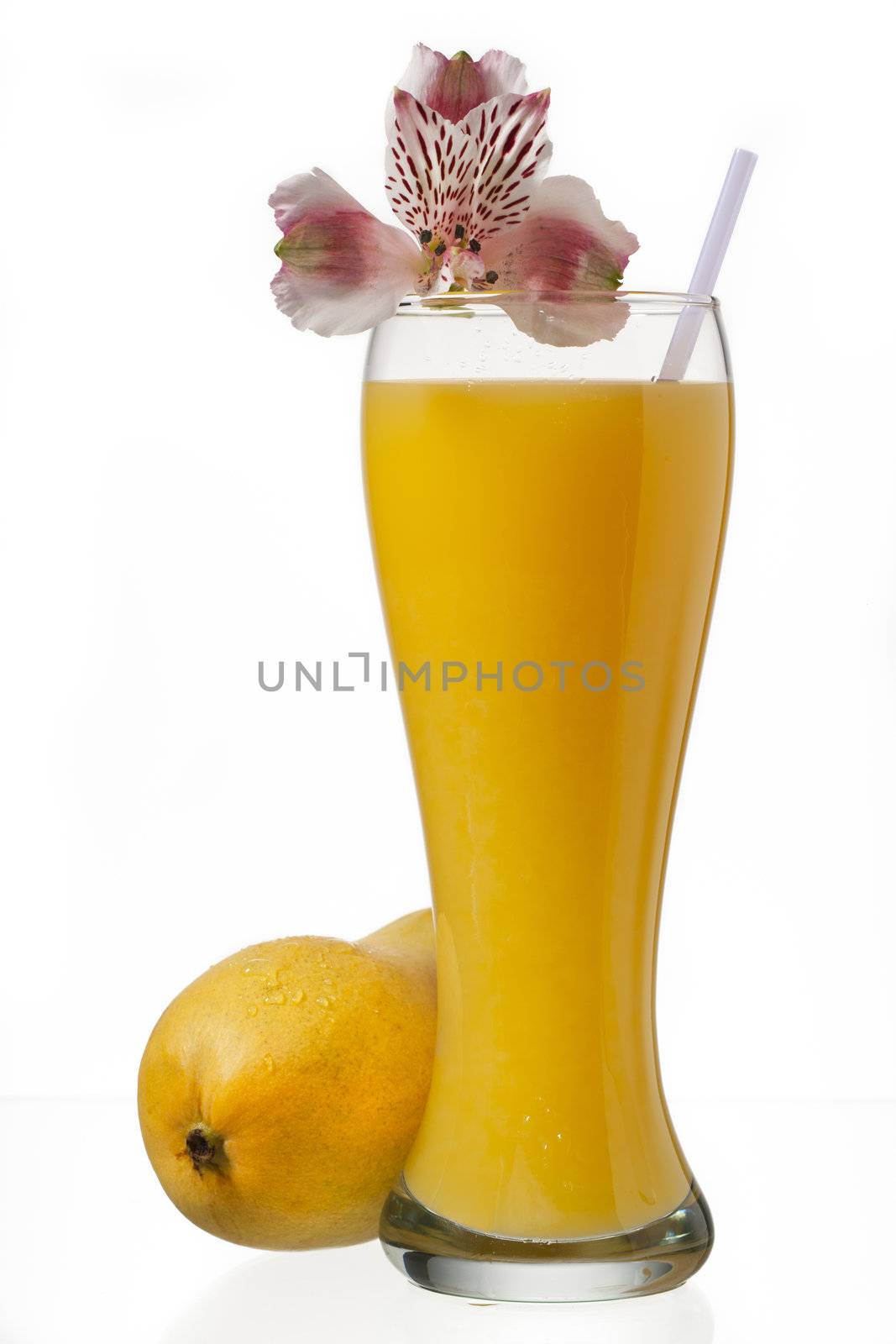 glass of mango juice and decorated with flowers on a white background