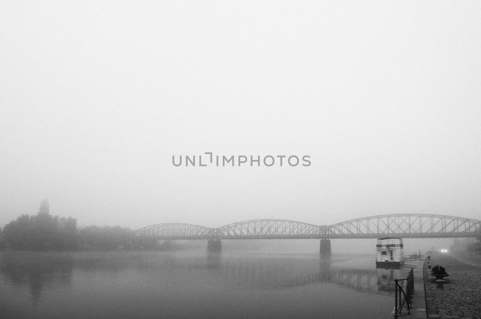 Prague railway bridge in early morning fog