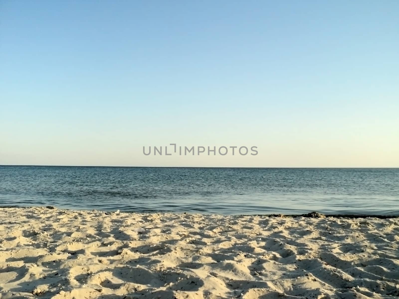           Seascape: general view of the desert of sandy beach and the sea                     