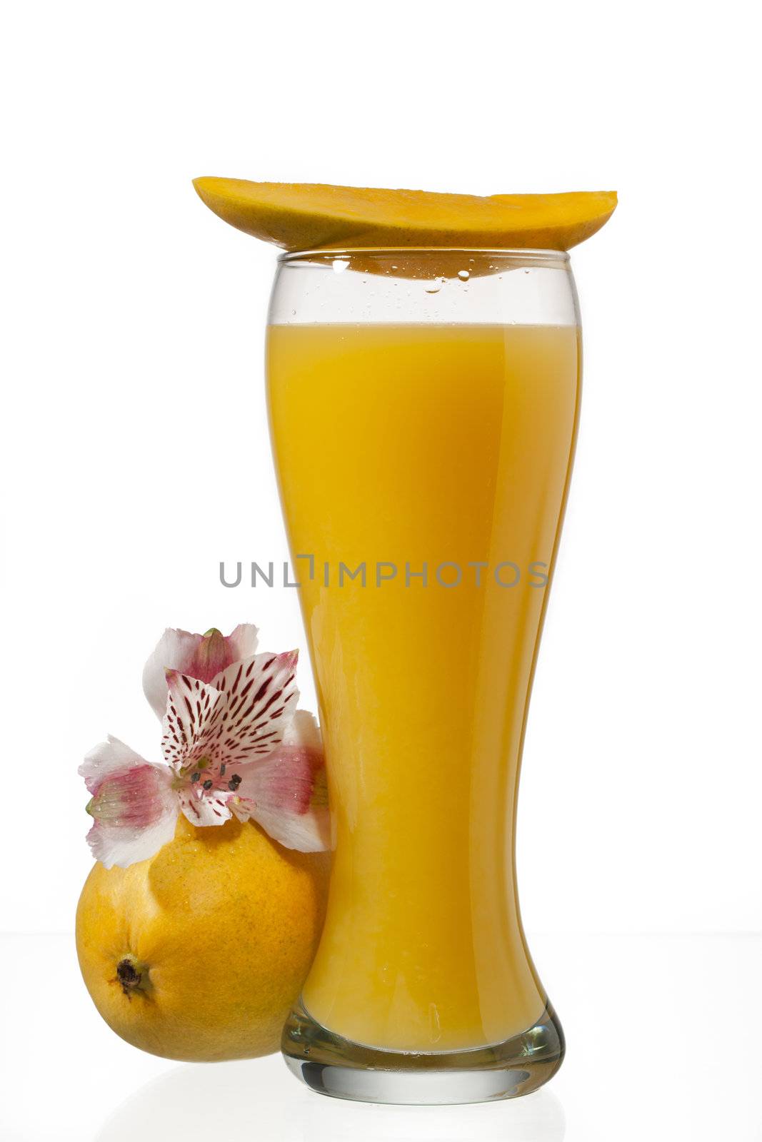 mango juice glass with slice of mango on top isolated on white background