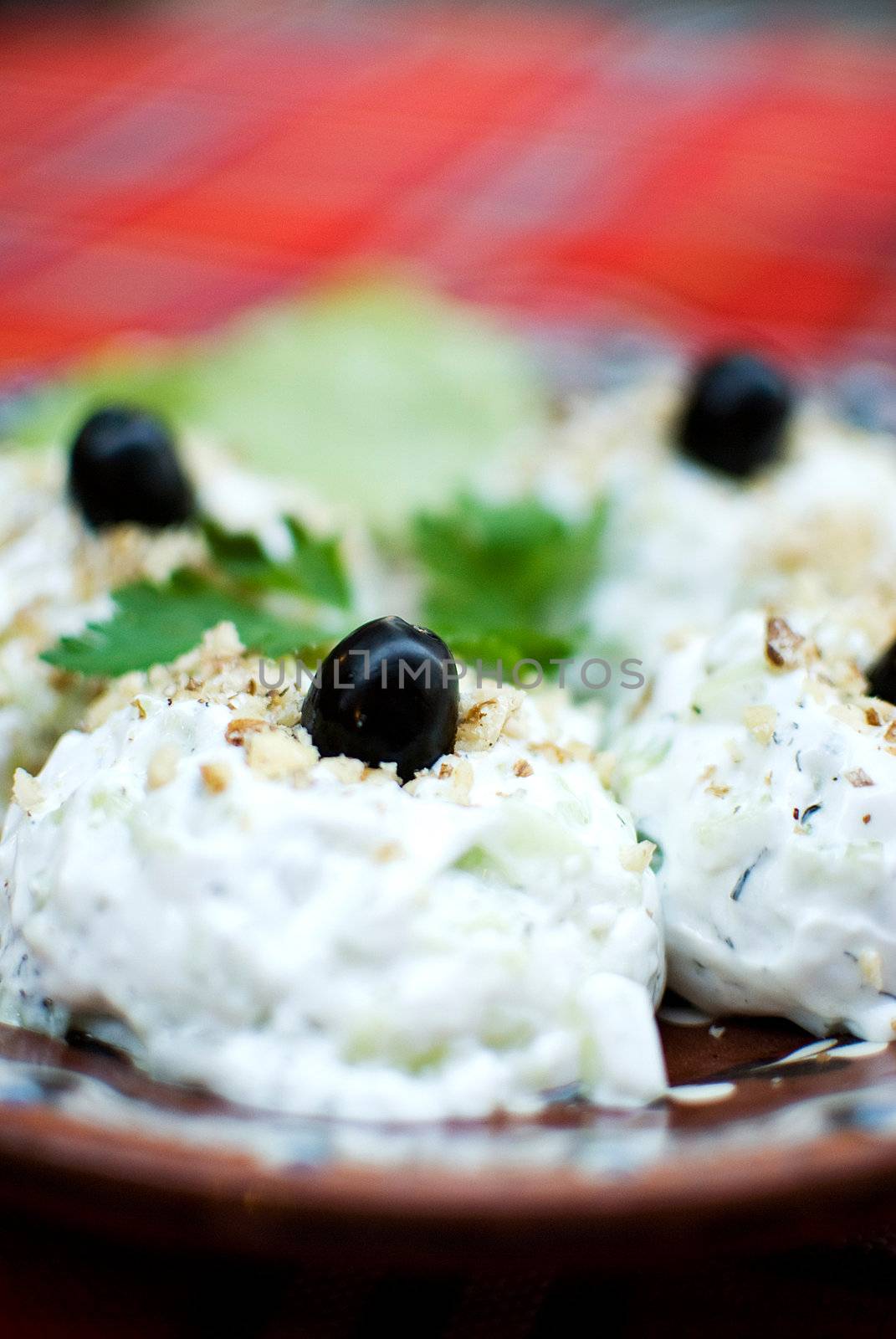 yoghurt and cucumber salad snejanka over typical bulgarian fabric and potery