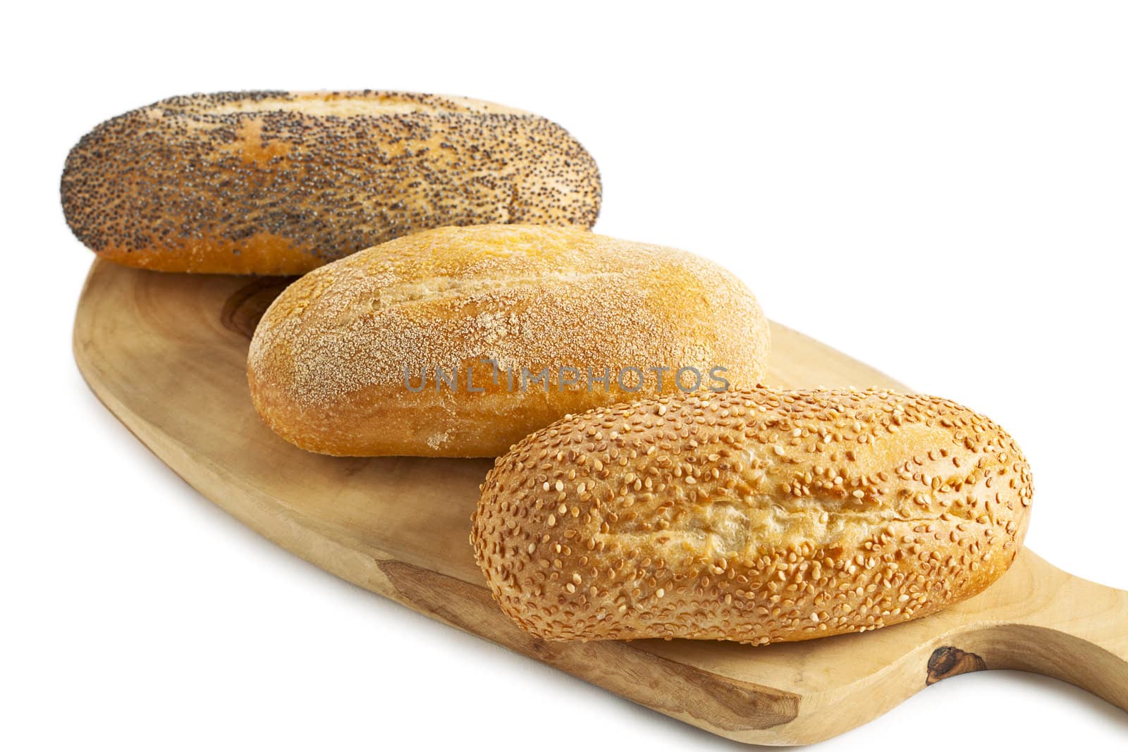 three breads on the wooden plank isolated on white background