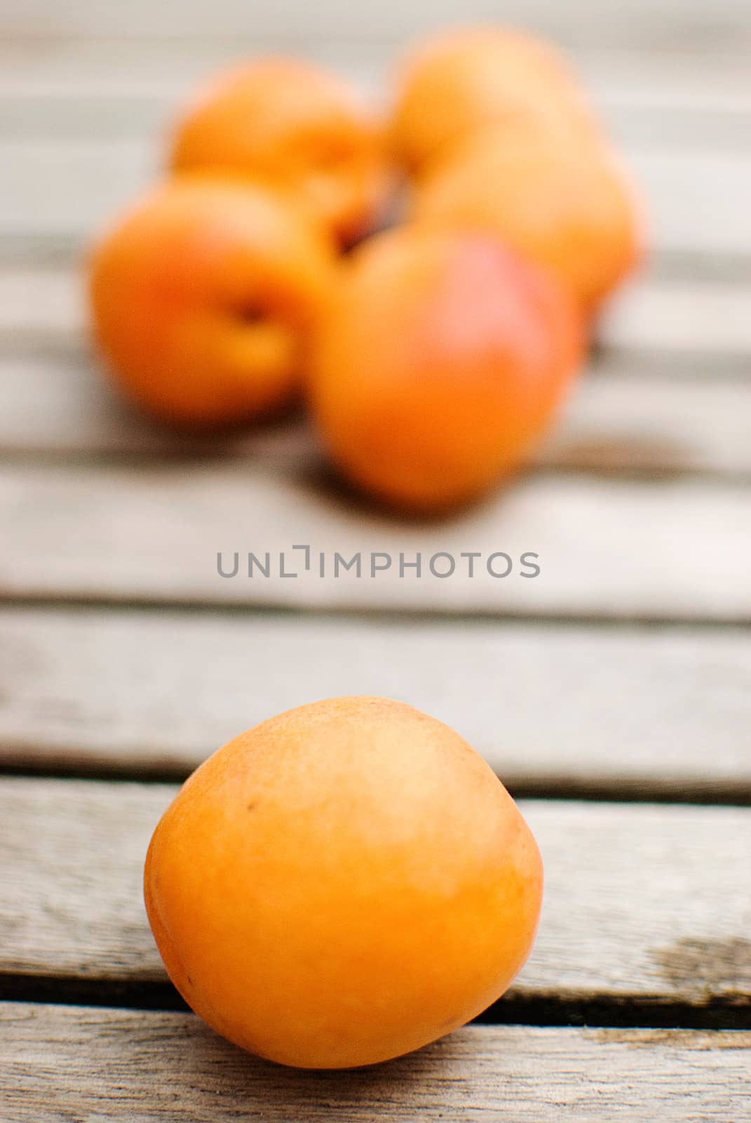 Fresh apricots over wooden table