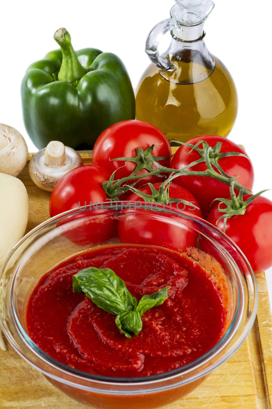 tomato sauce with tomato olive oil  green paper and mushroom in a wooden board