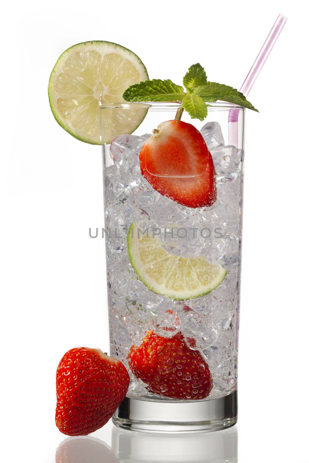 glass of ice cubes with lemon slice  and strawberries on a white background