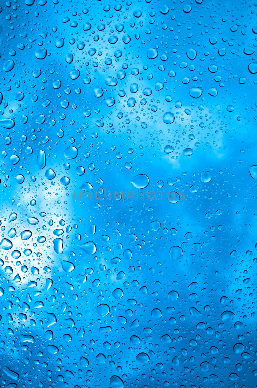background image of rain drops on glass with a bright blue cooling color behind