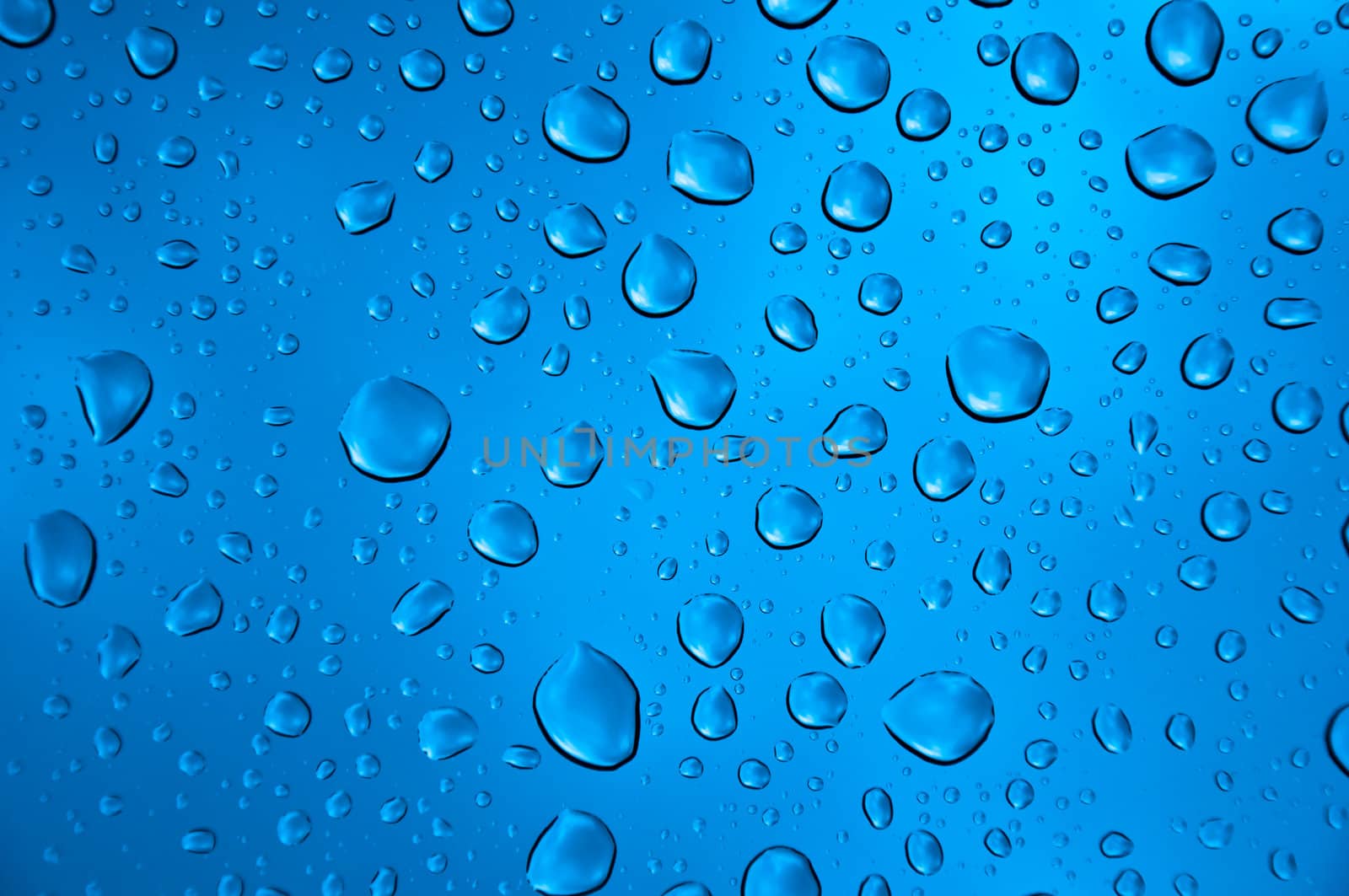 background image of rain drops on glass with a bright blue cooling color behind