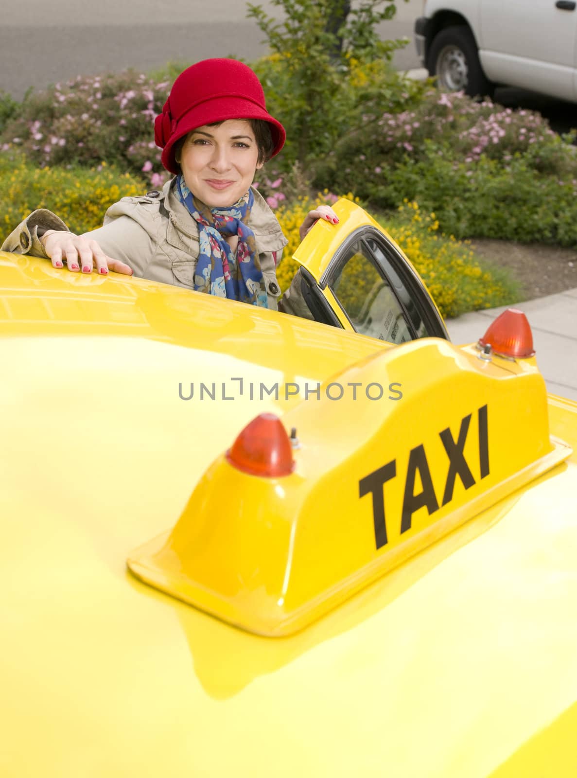 Beautiful woman enters a yellow taxi