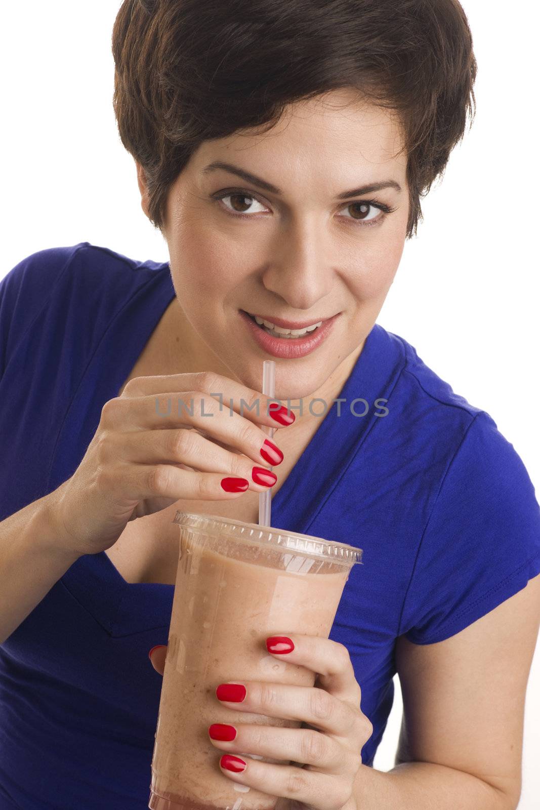 Beautiful woman with manicured nails sips a neutral colored smoothie