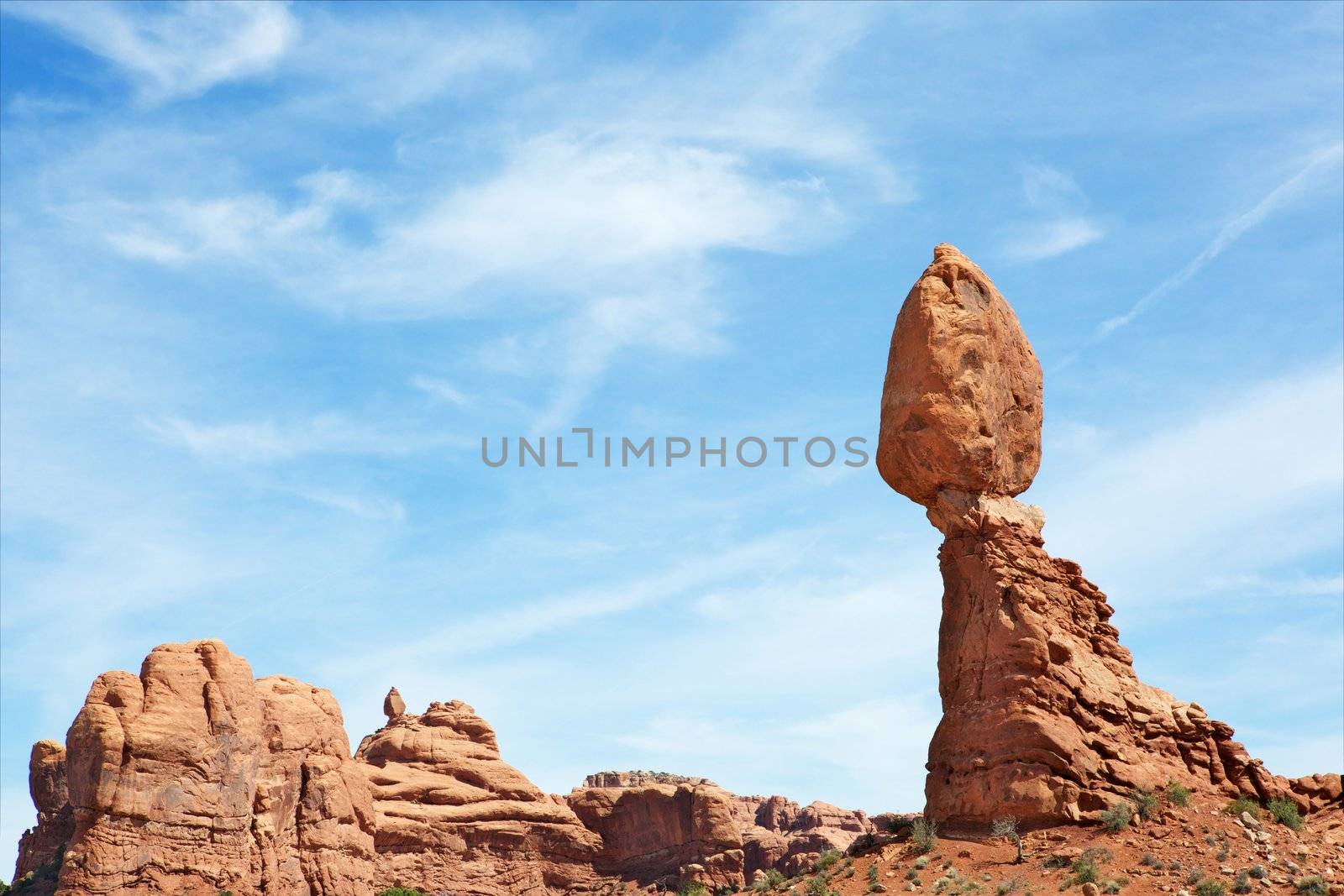Arches National park balancing rock at during day against dramatic sky