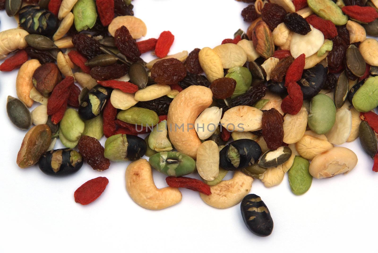 organic mixed nuts and dry fruits on white background
