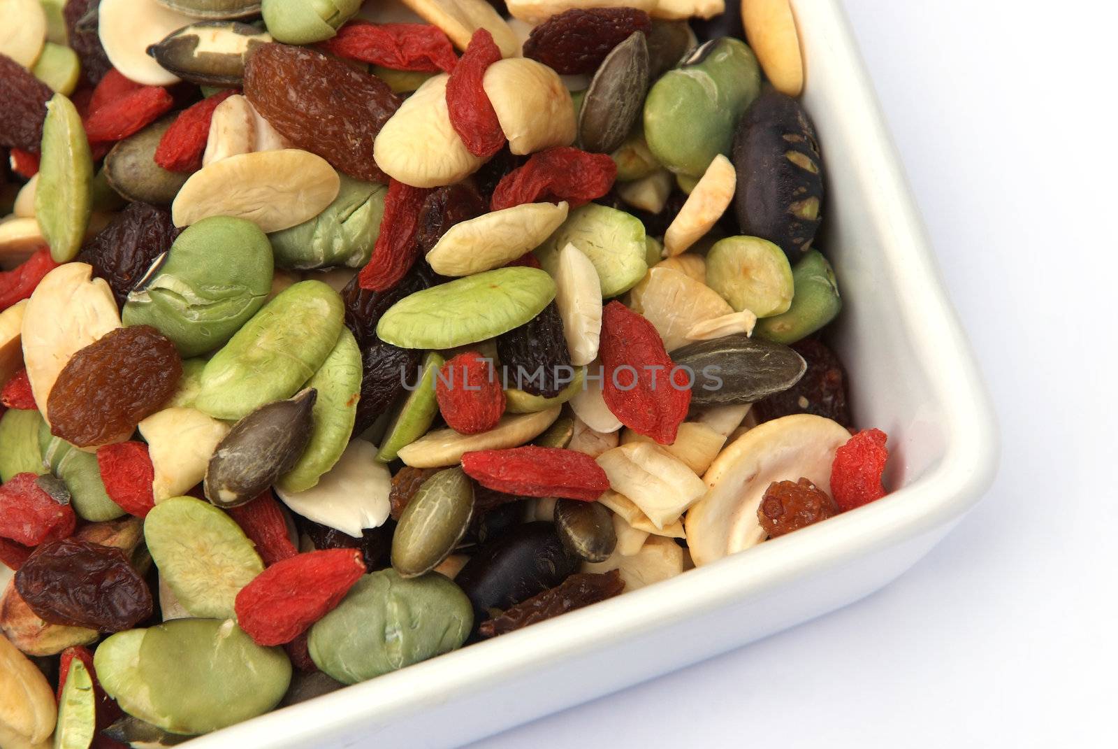 organic mixed nuts and dry fruits on white background