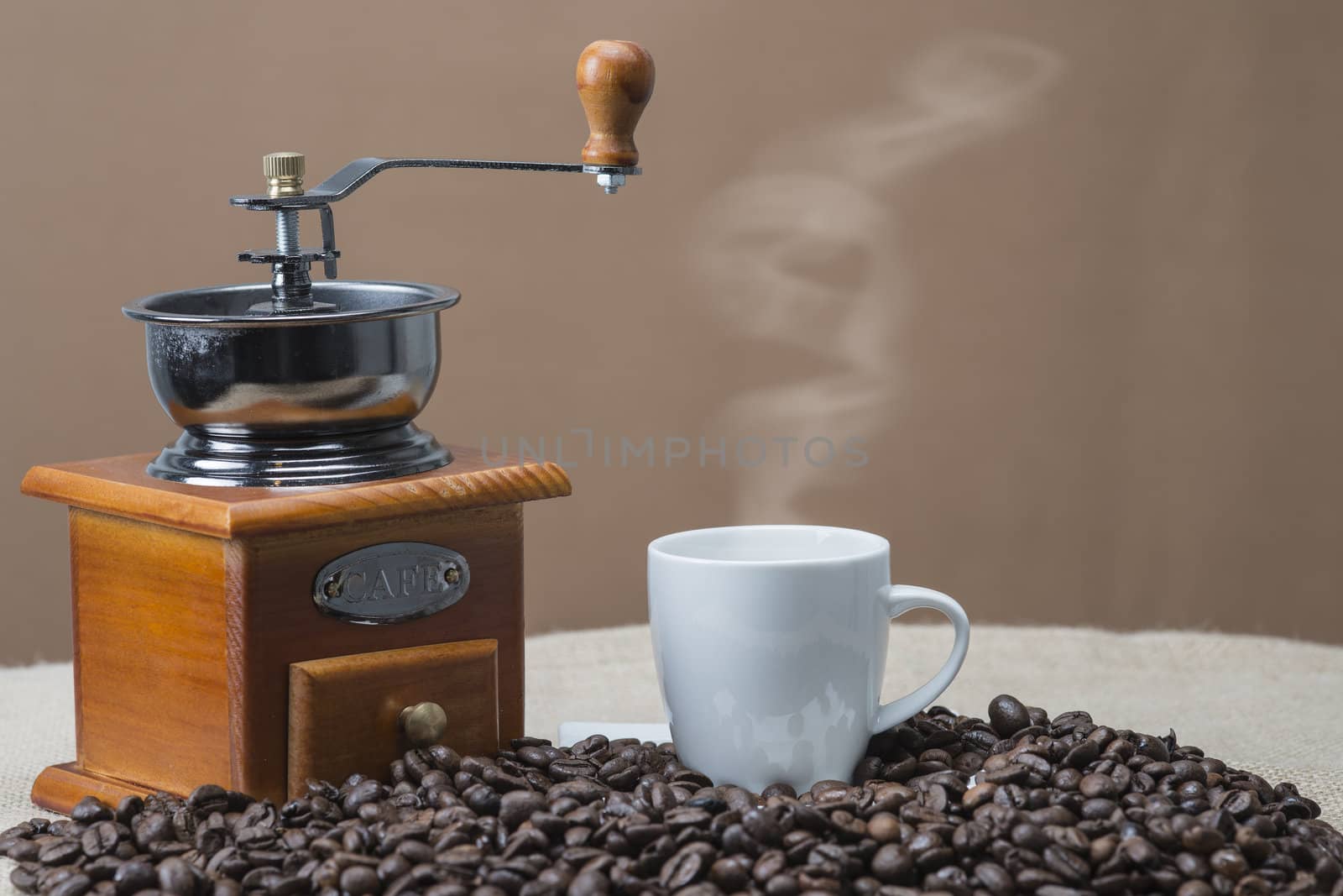 Steaming coffee beside the grinder by angelsimon
