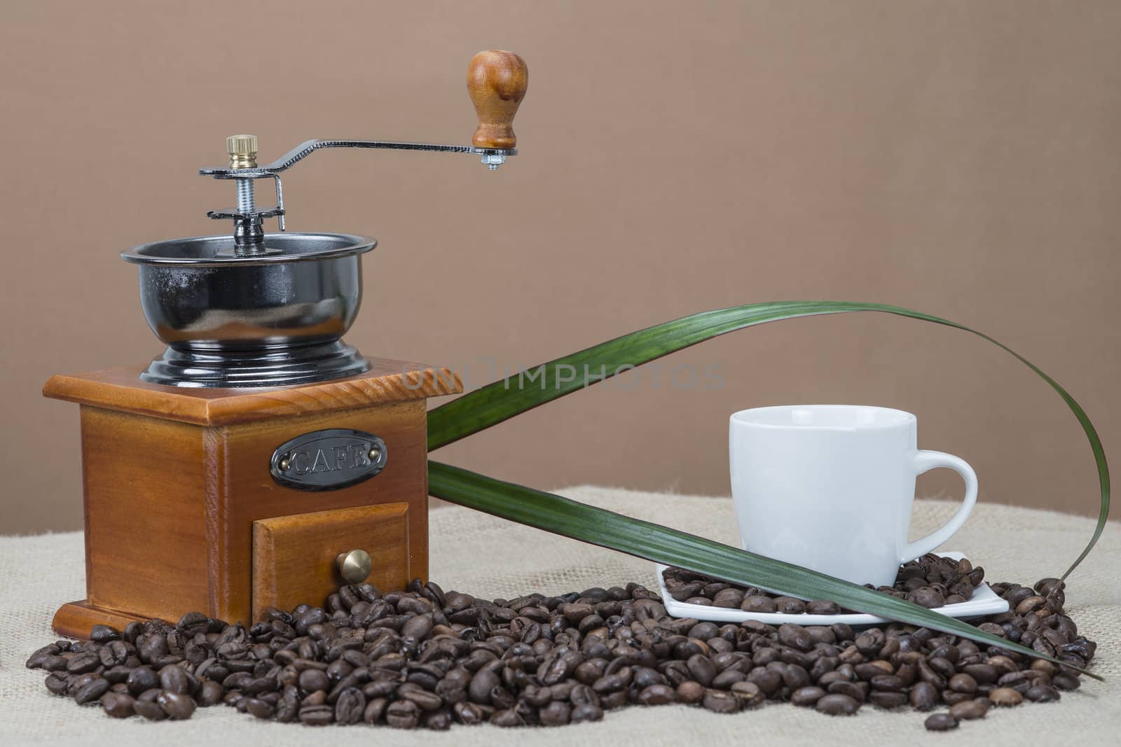 Coffee grinder and cups on some bean by angelsimon