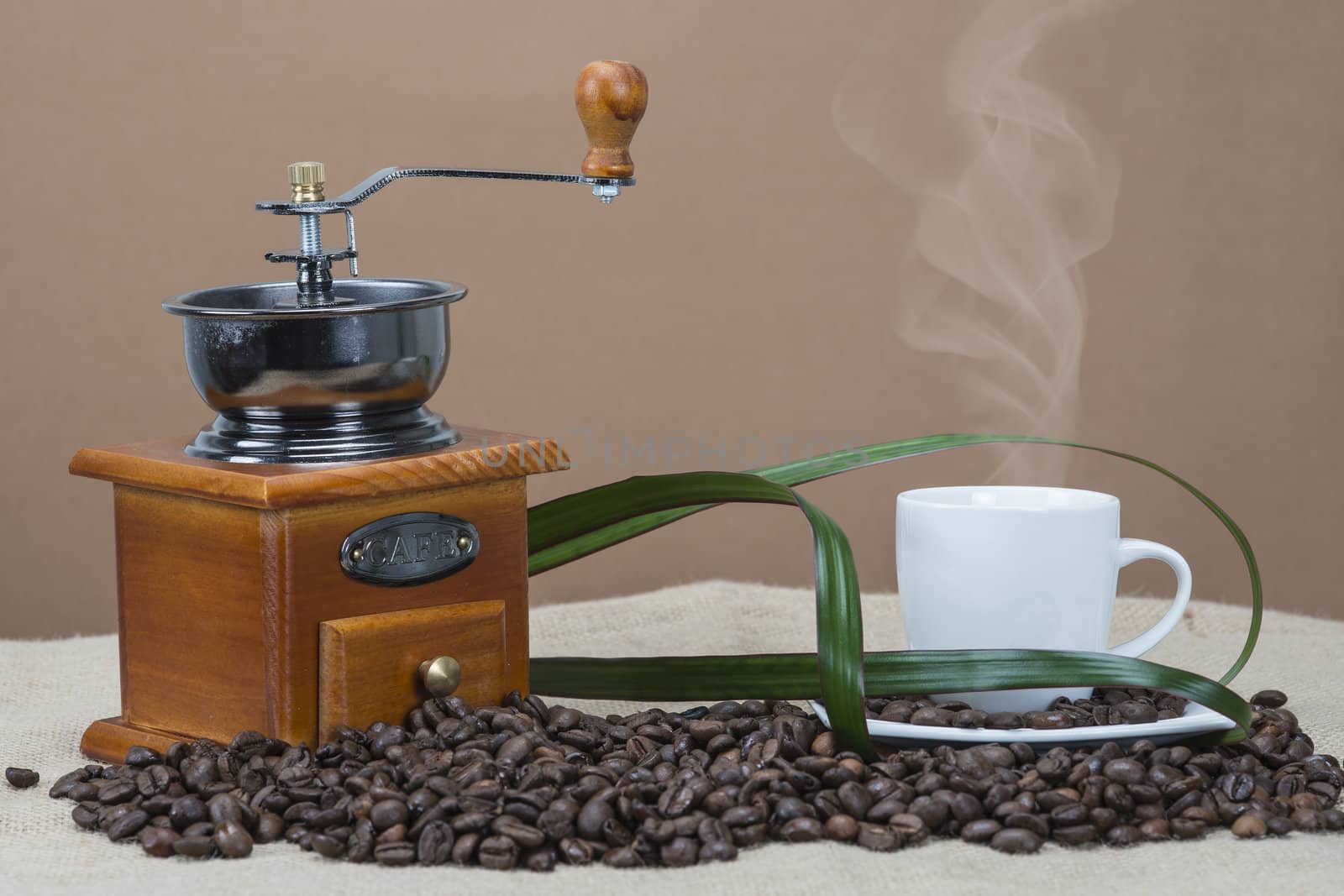 Steaming coffee beside the grinder by angelsimon