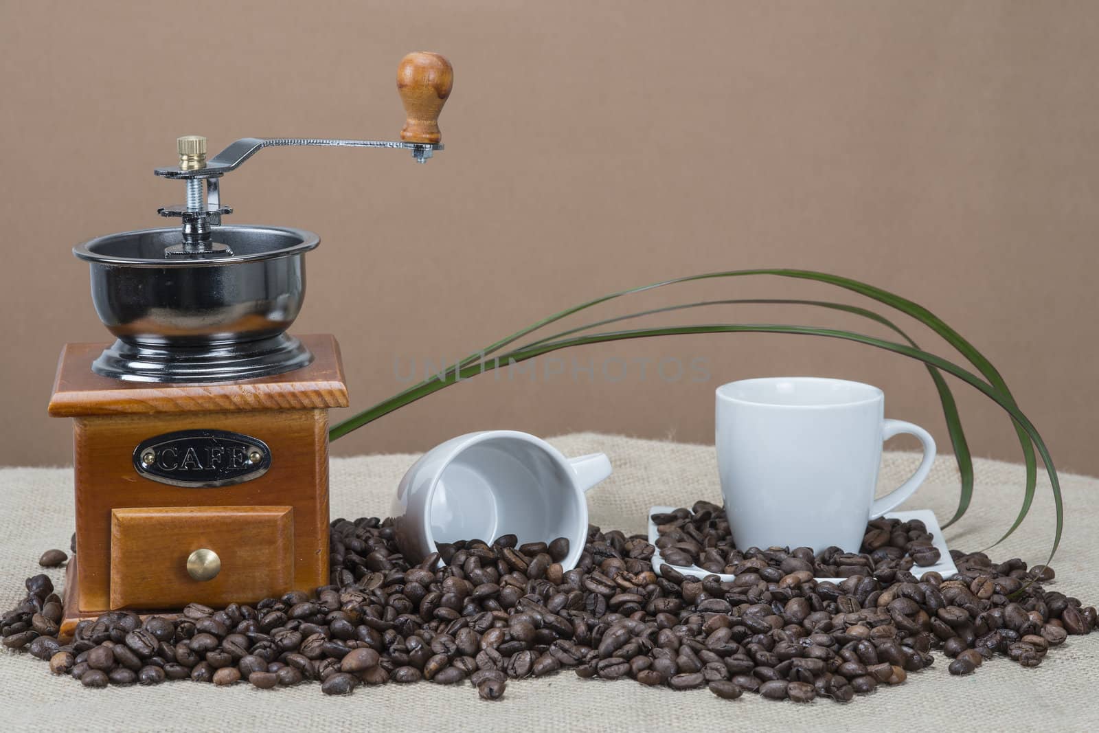 Still life about coffee with cups, beans and a mill