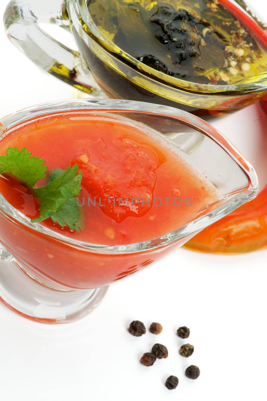 Salsa Sause and Olive Oil with Herbs in Glass Gravy Boat isolated on white background