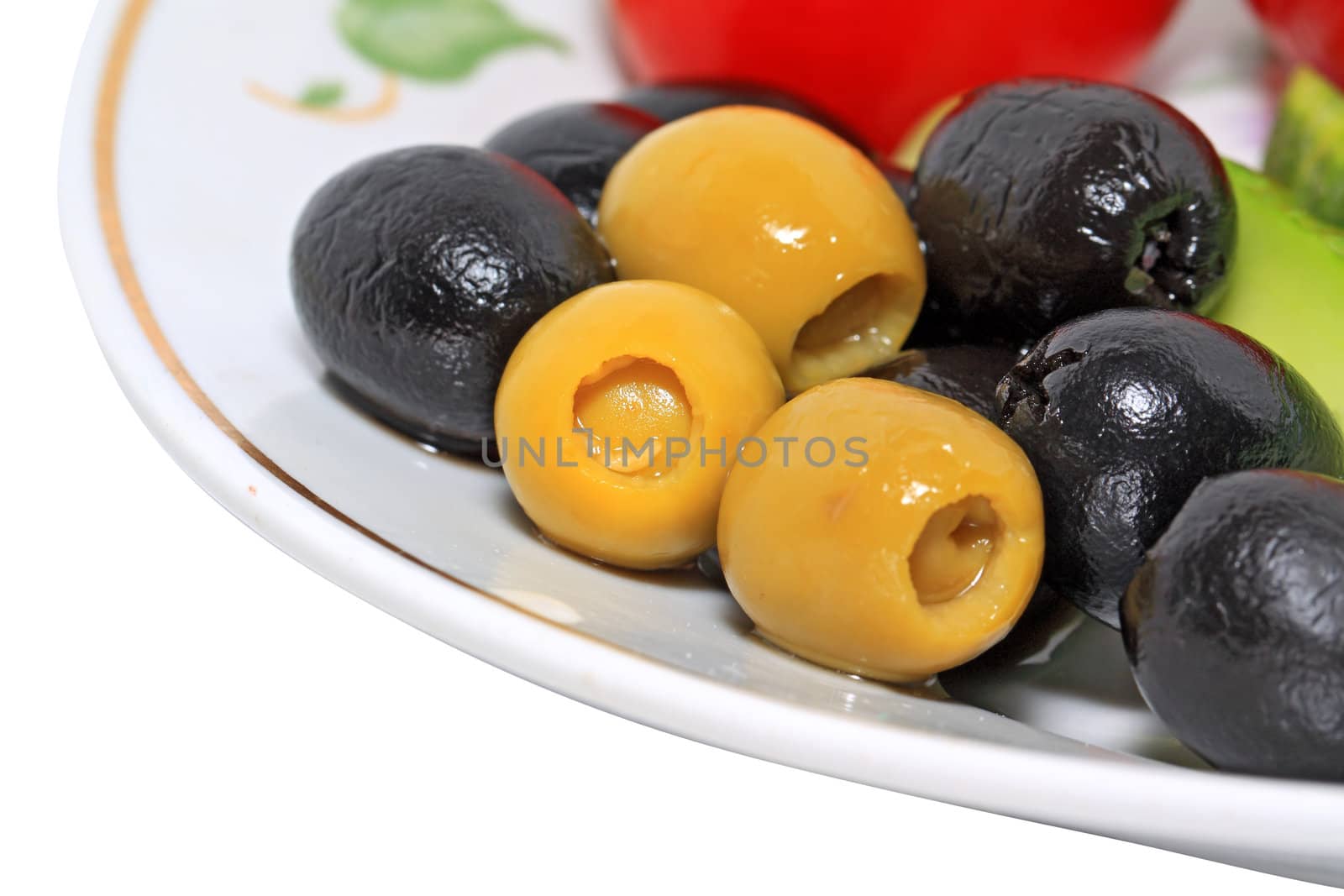 olives in a blue plate on a white background by basel101658