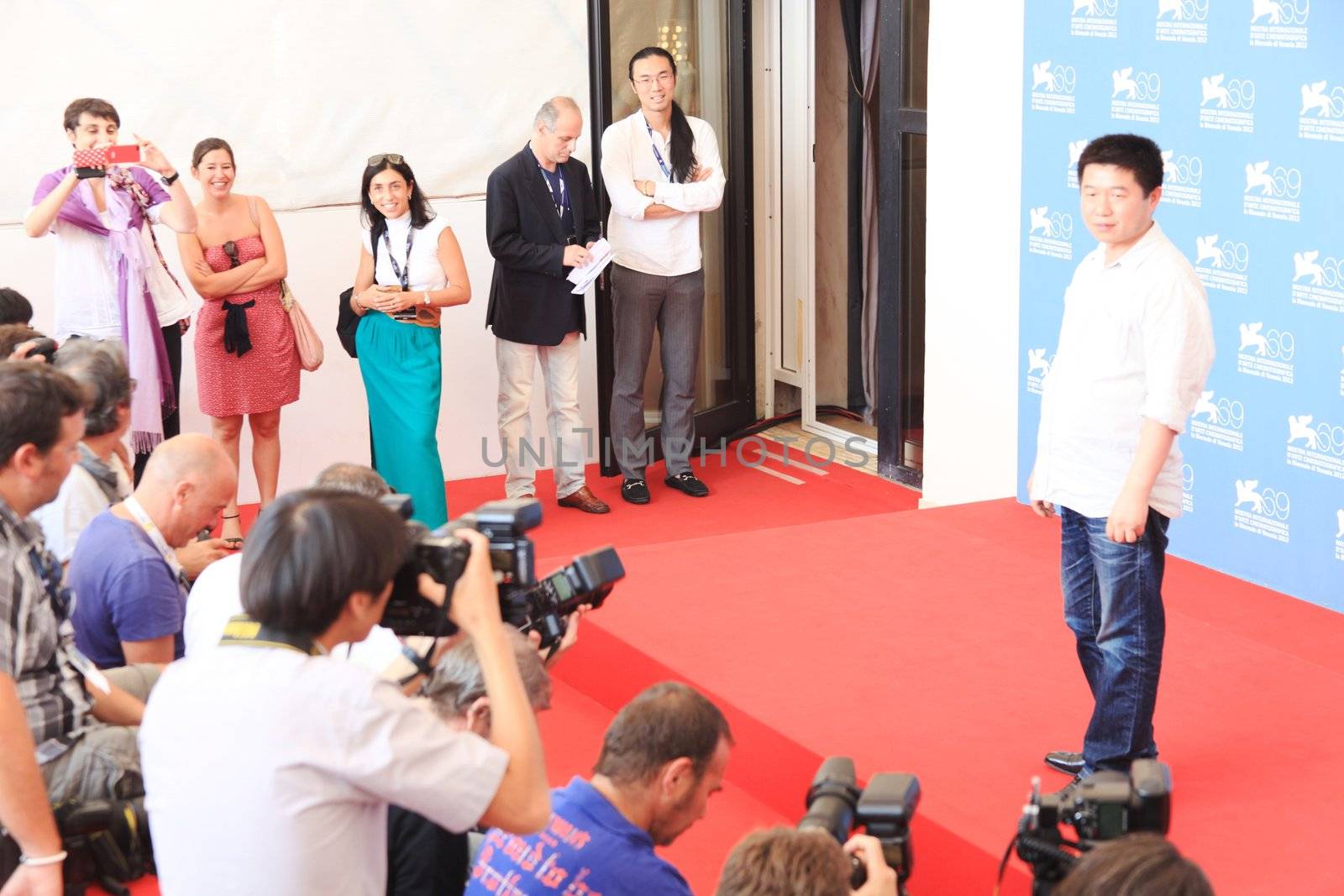 Wang Bing poses for photographers at 69th Venice Film Festival