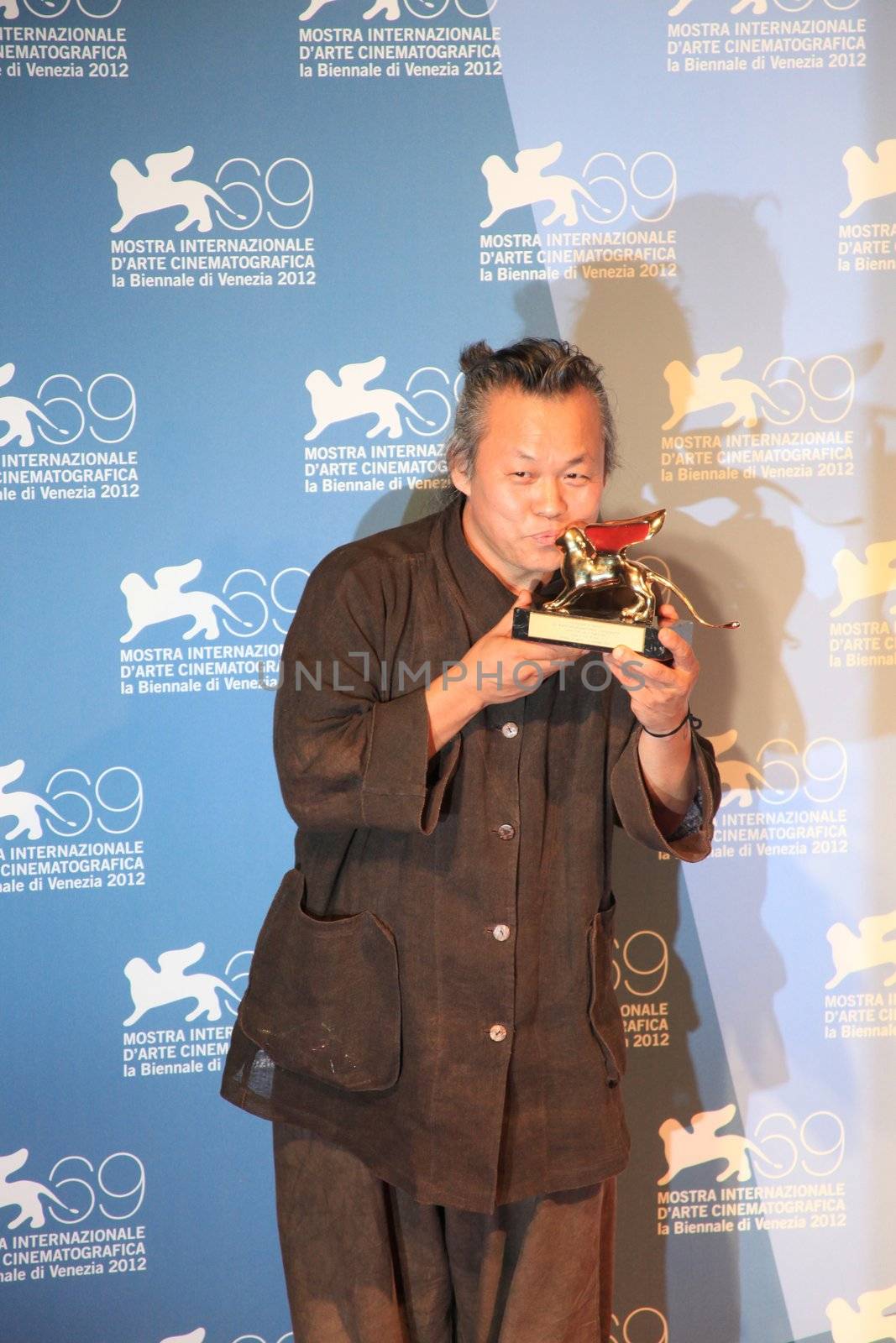 Kim Ki-duk poses for photographers at 69th Venice Film Festival