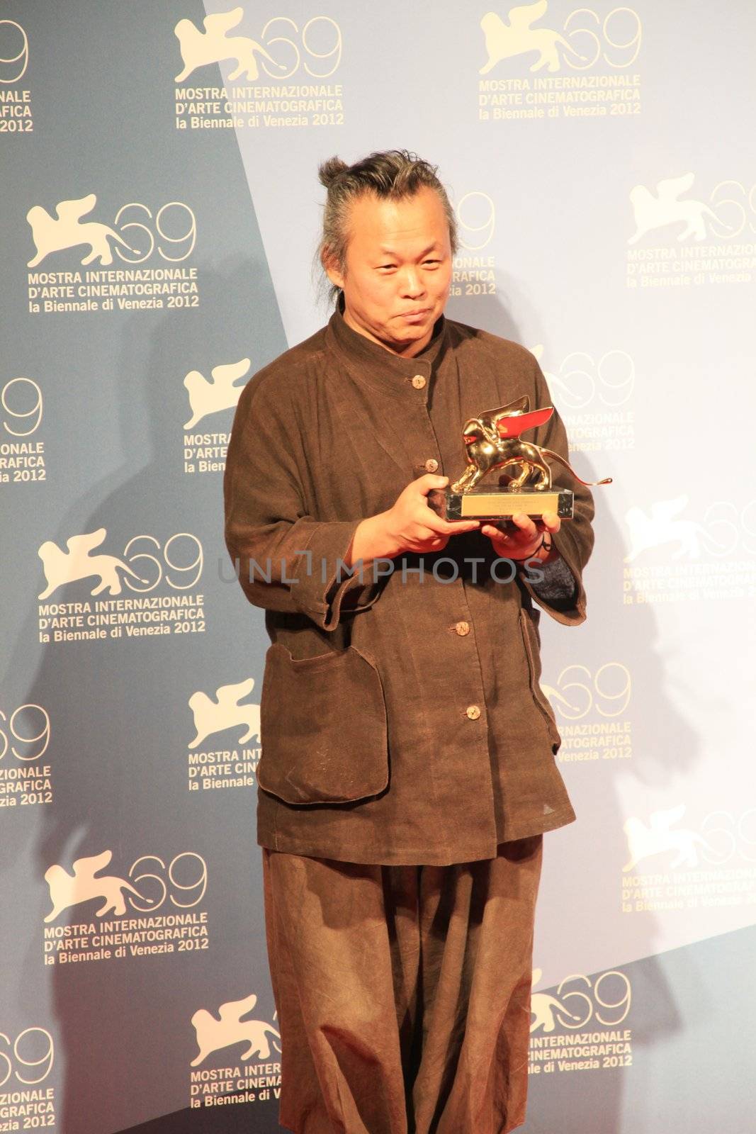 Kim Ki-duk poses for photographers at 69th Venice Film Festival
