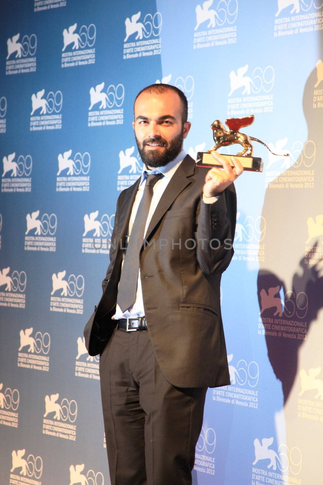 Ali Aydin poses for photographers at 69th Venice Film Festival