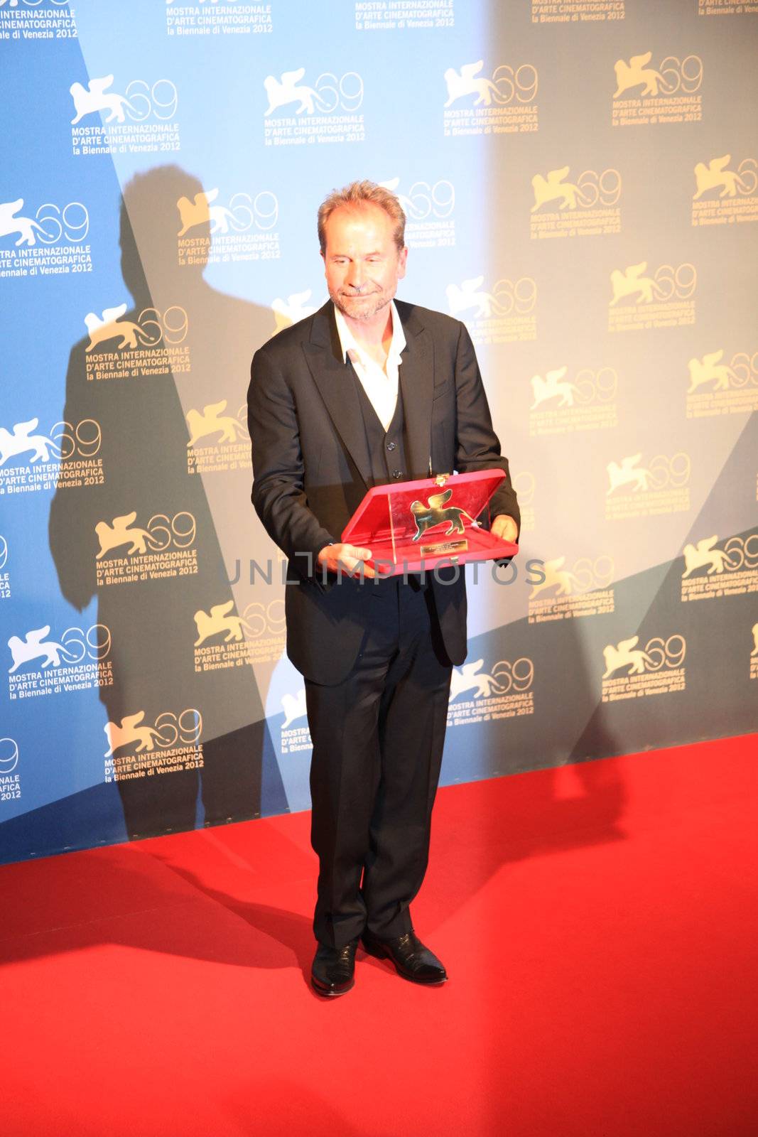 Ulrich Seidl poses for photographers at 69th Venice Film Festival