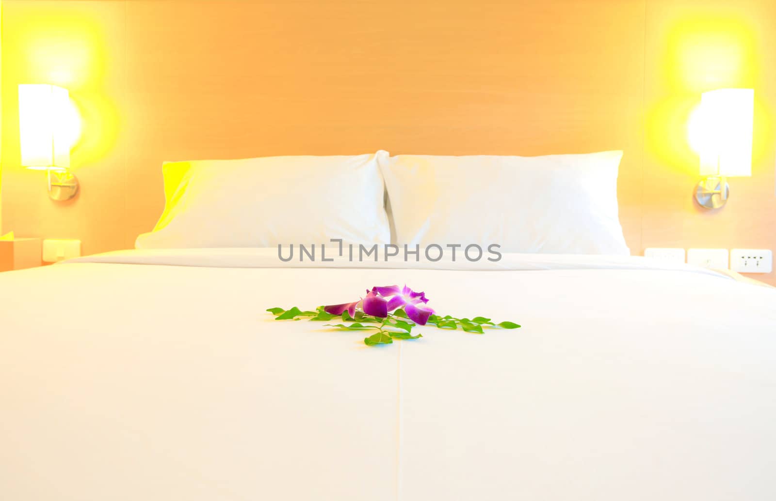 Interior of modern bedroom (selective focus on orchid flowers decoration)