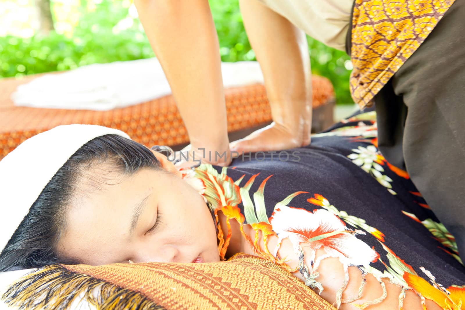 Back Massage Spa with Hand in tropical garden for wellness and healthy background