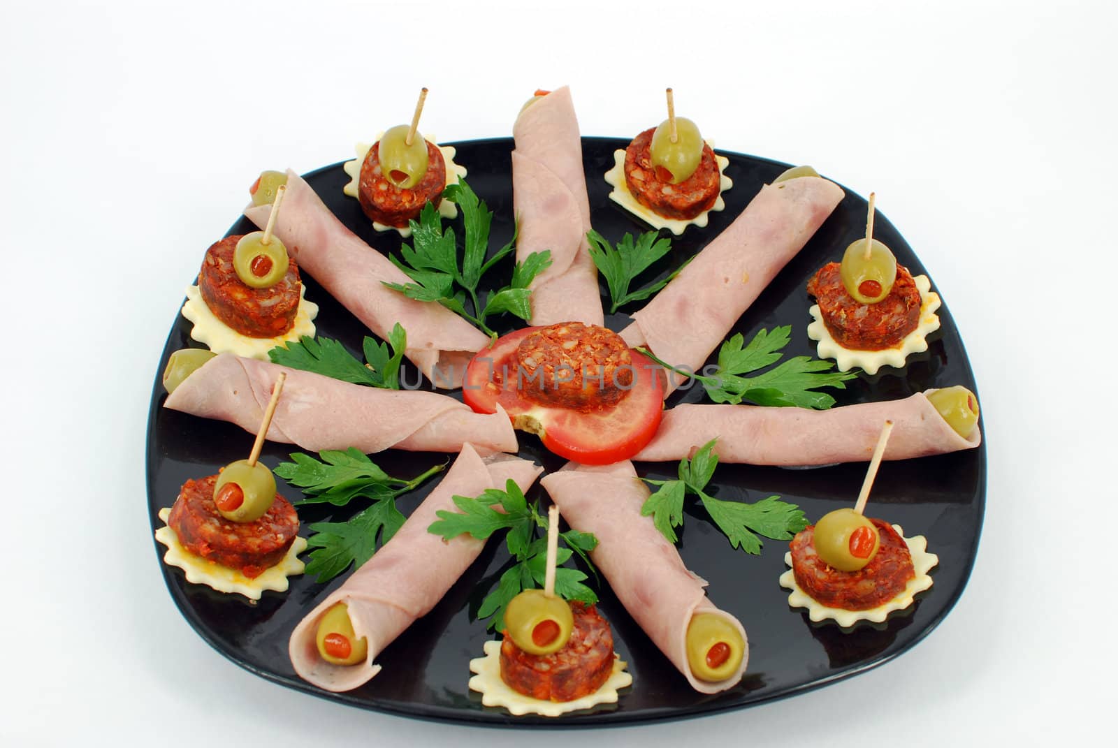 Decorative catering food on black dish