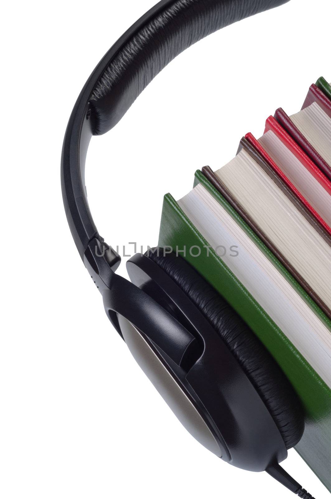 Headphones on books with color covers isolated white background.