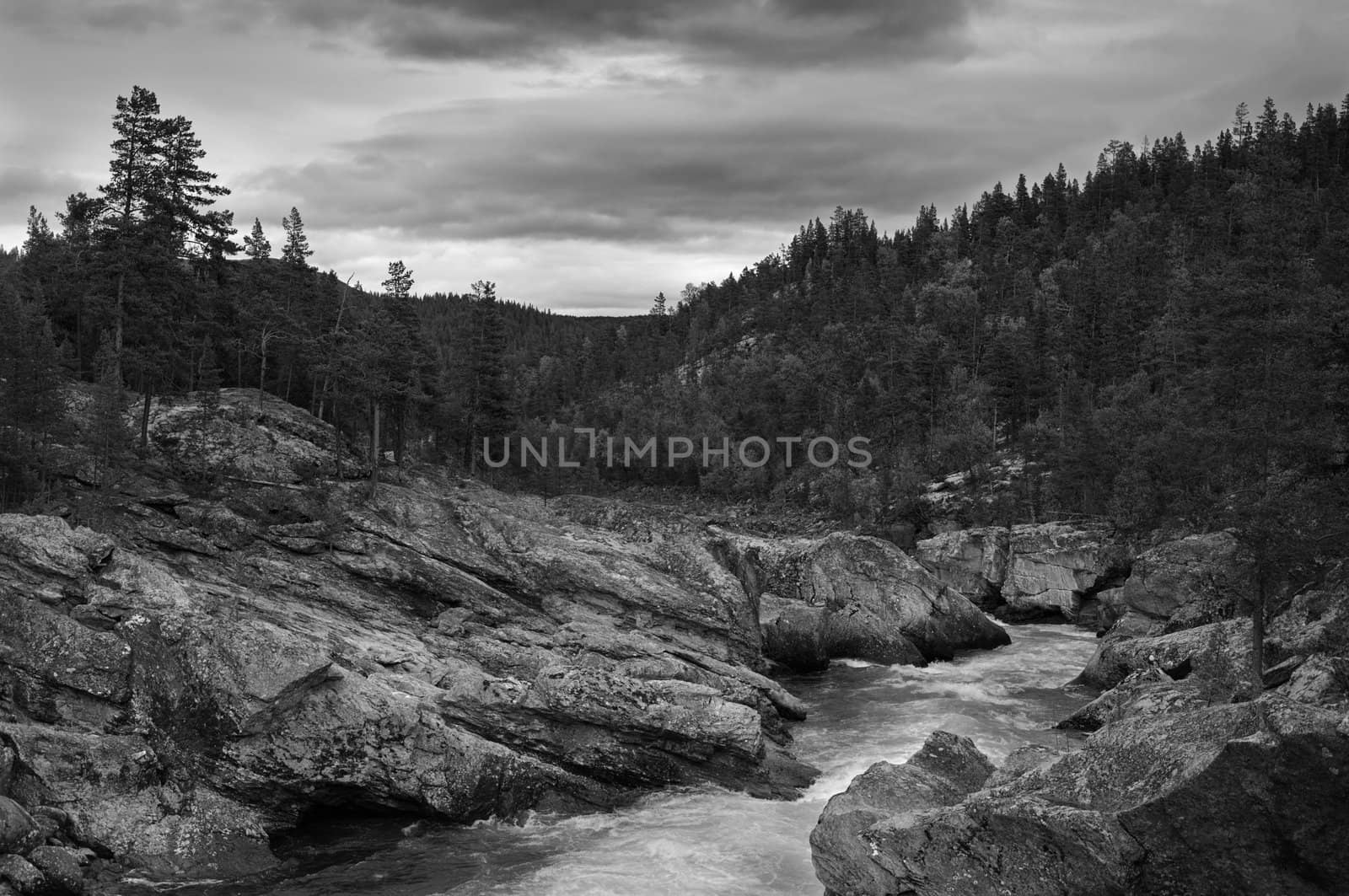 Mountain river black and white dramatic landscape.