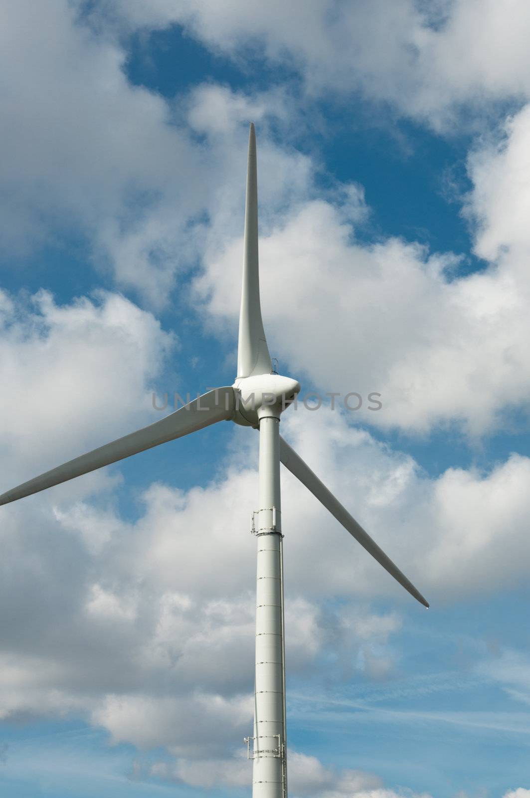 Propeller wind power generator on the background of sky. Rear view.