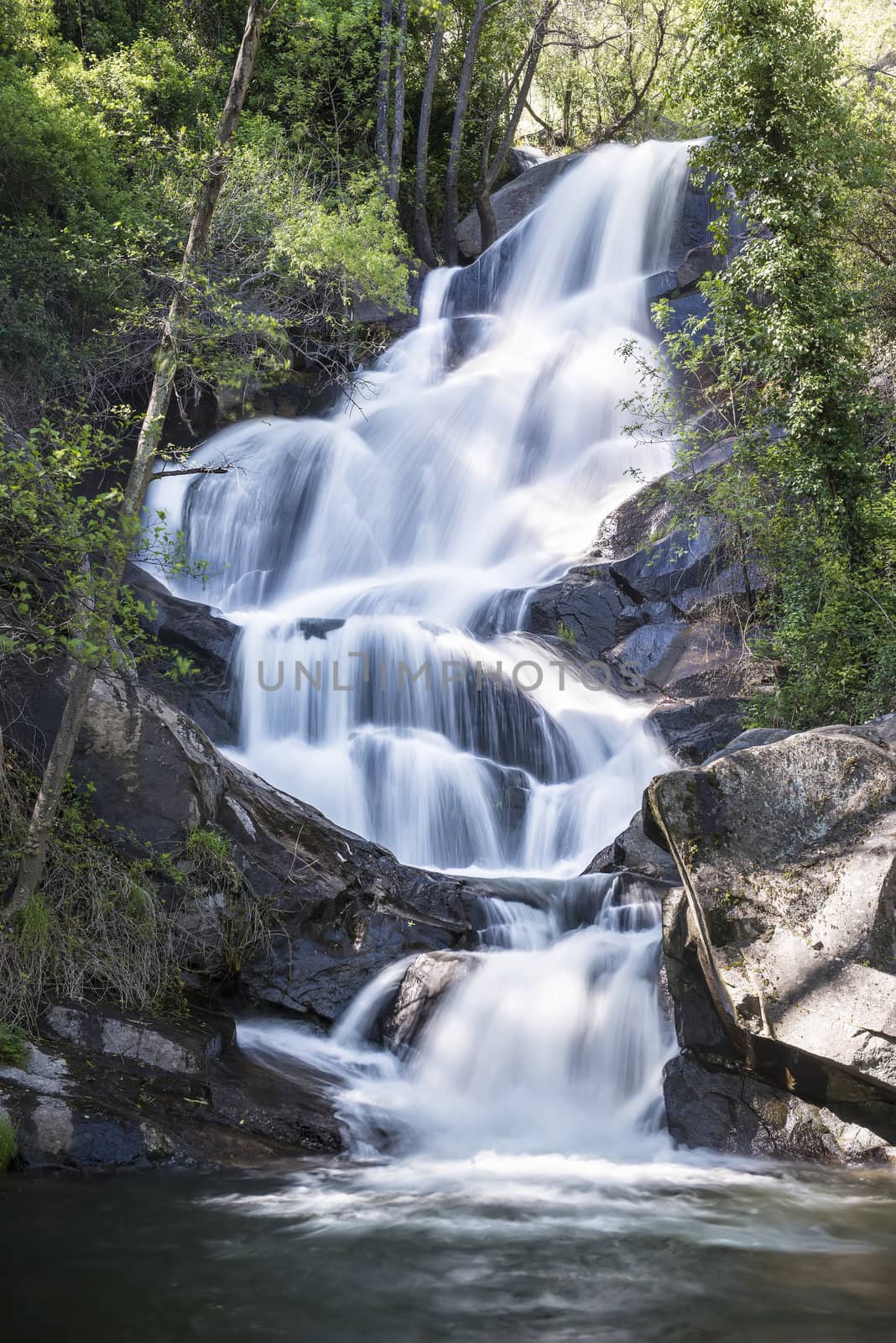 Cascades on a mountain river with a silky effect on the water that conveys a sense of relaxation.