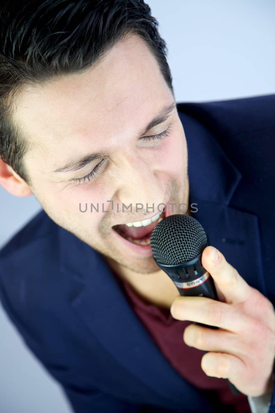 Man singing with passion into microphone