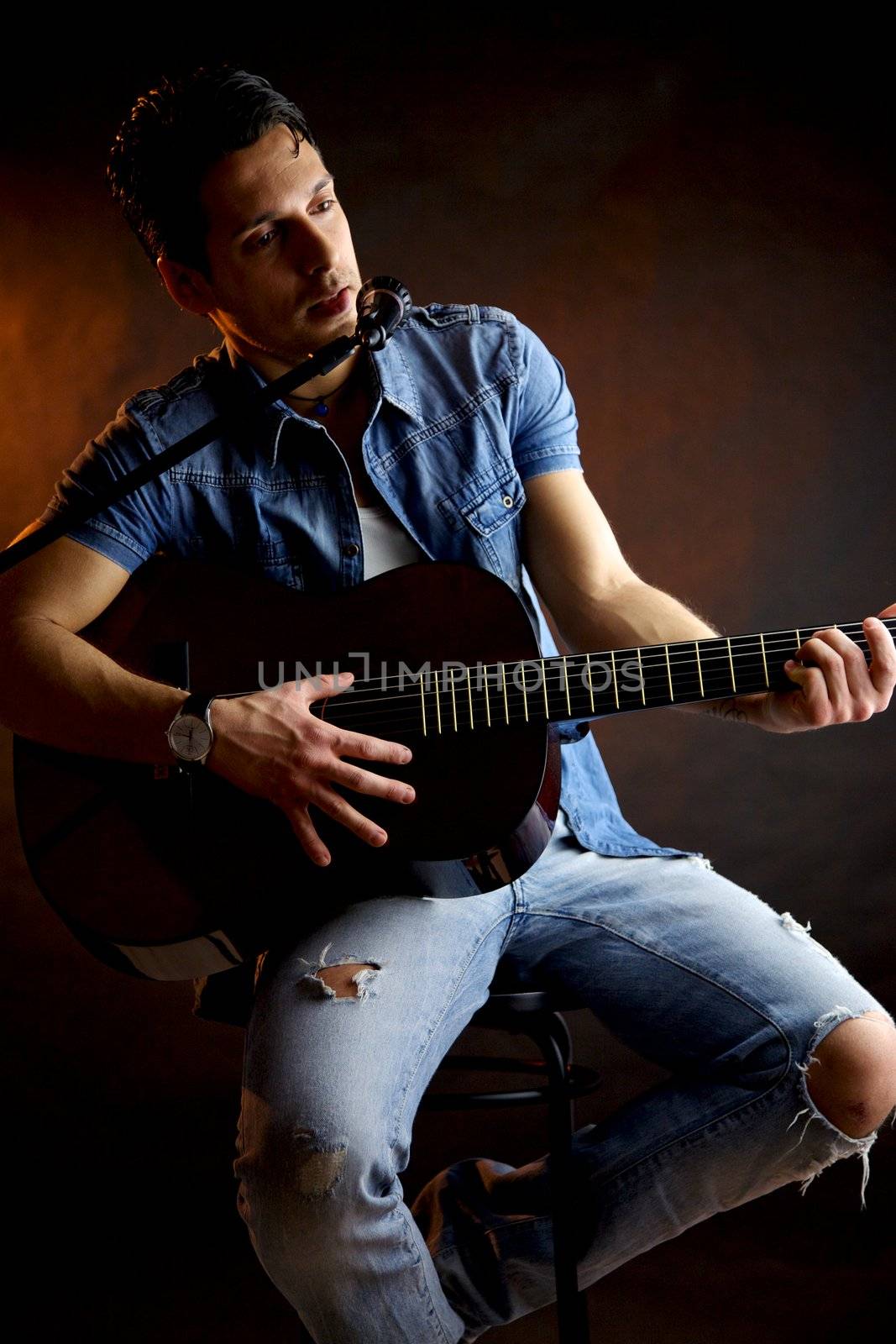 Serious male model with guitar intense