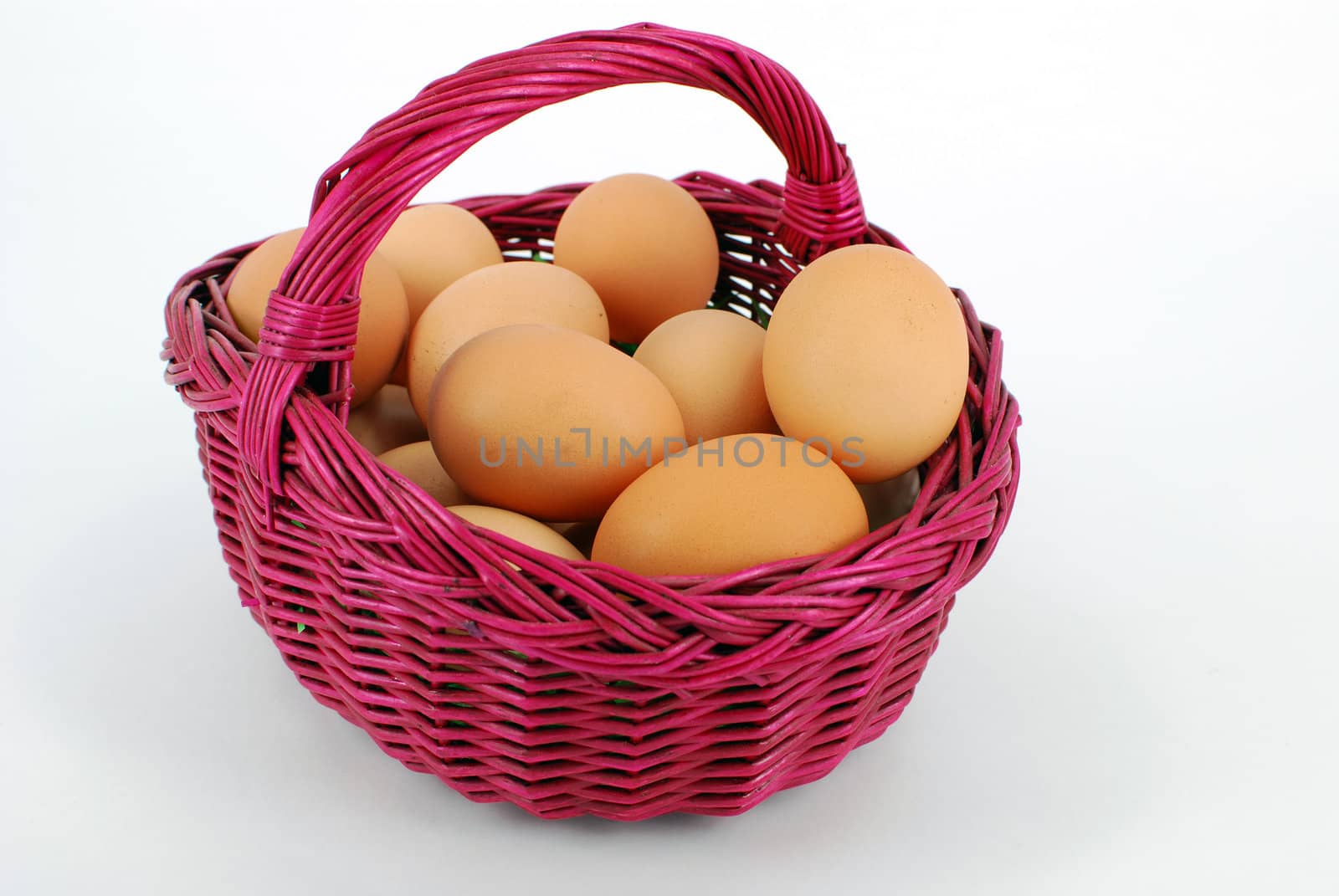 Basket with eggs on white