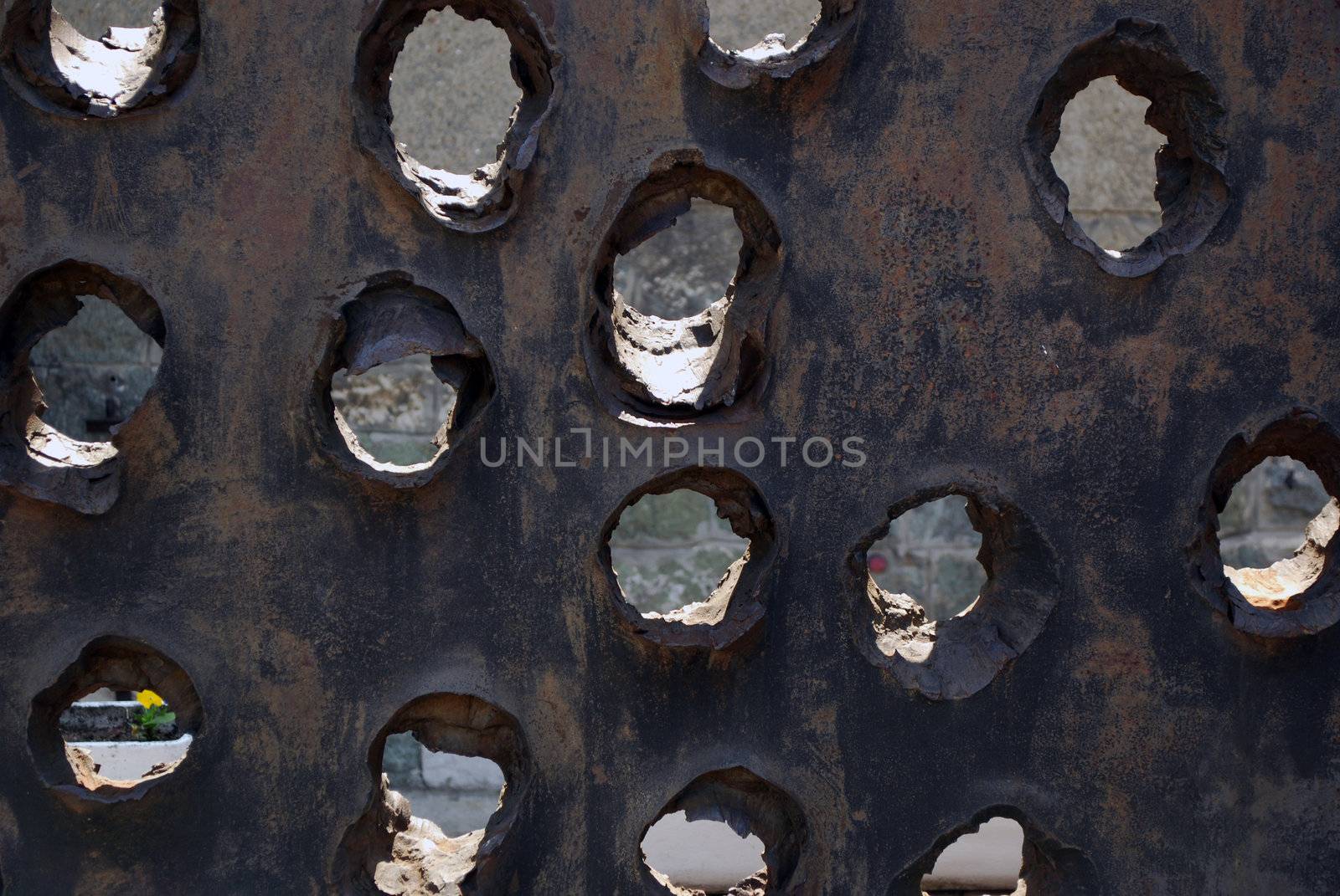 Iron plate with holes from piercing anti armor grenade