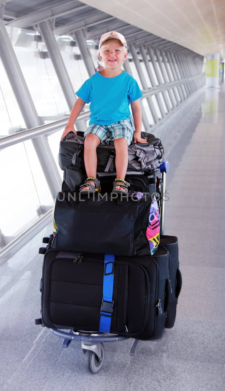 young boy is sitting on the baggage car