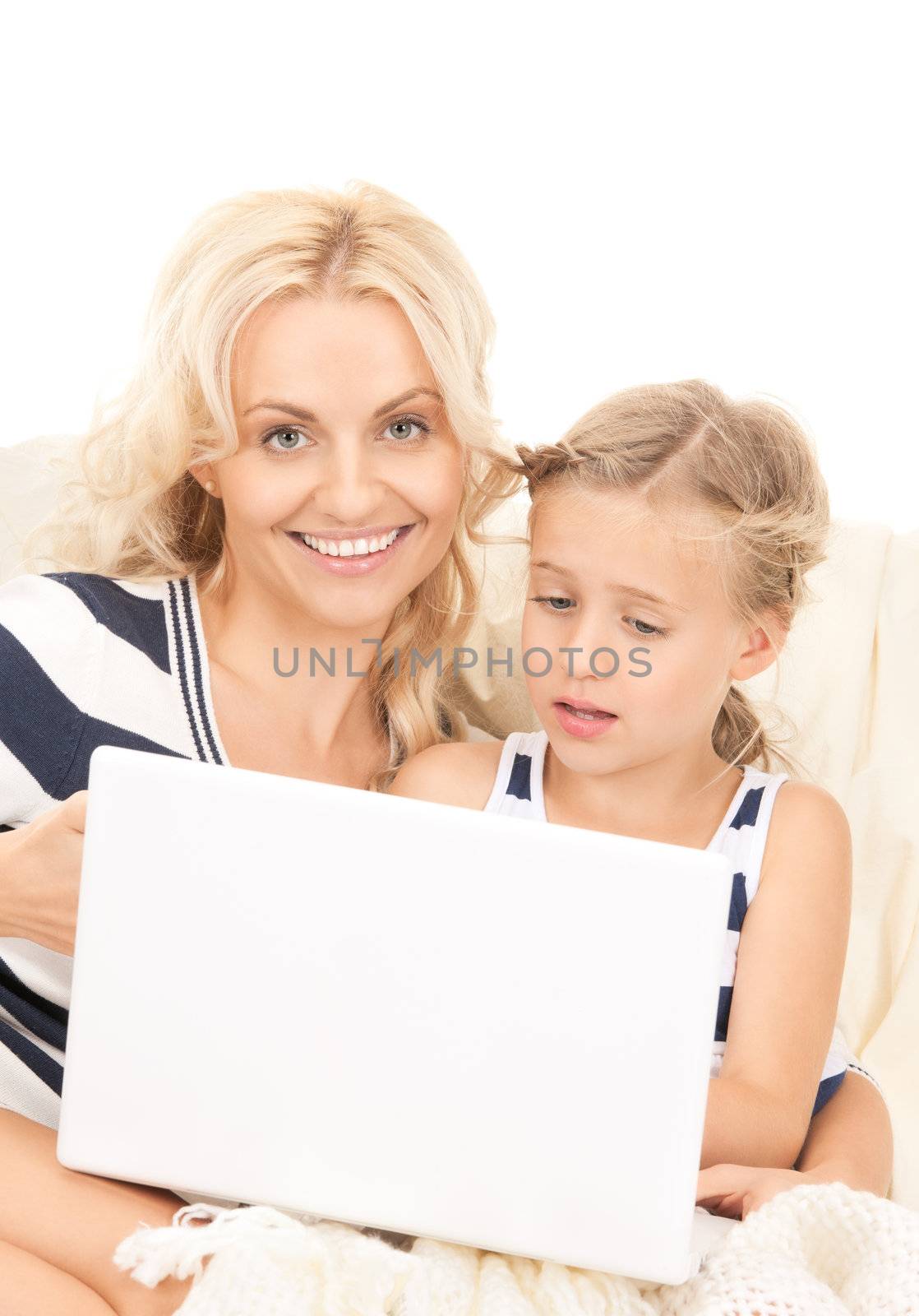 bright picture of happy mother and child with laptop computer