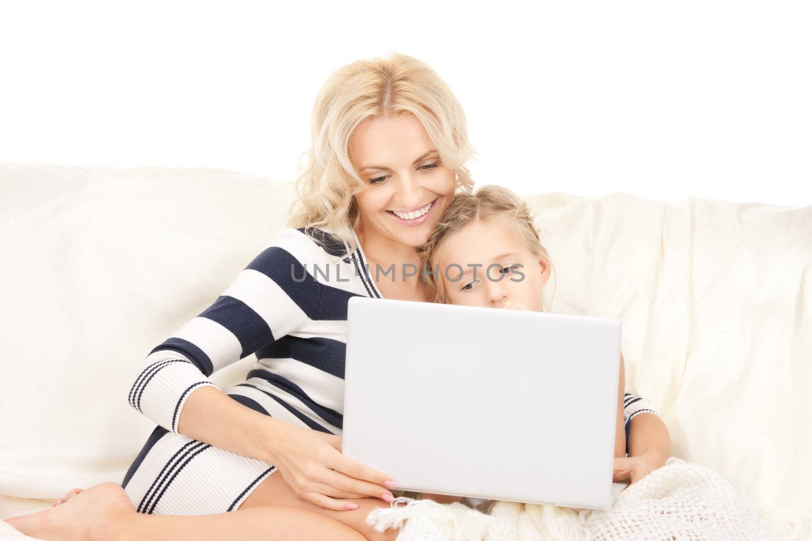 bright picture of happy mother and child with laptop computer