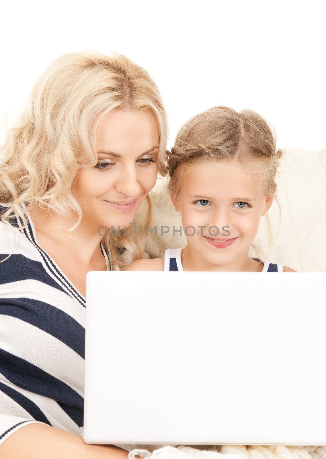 bright picture of happy mother and child with laptop computer