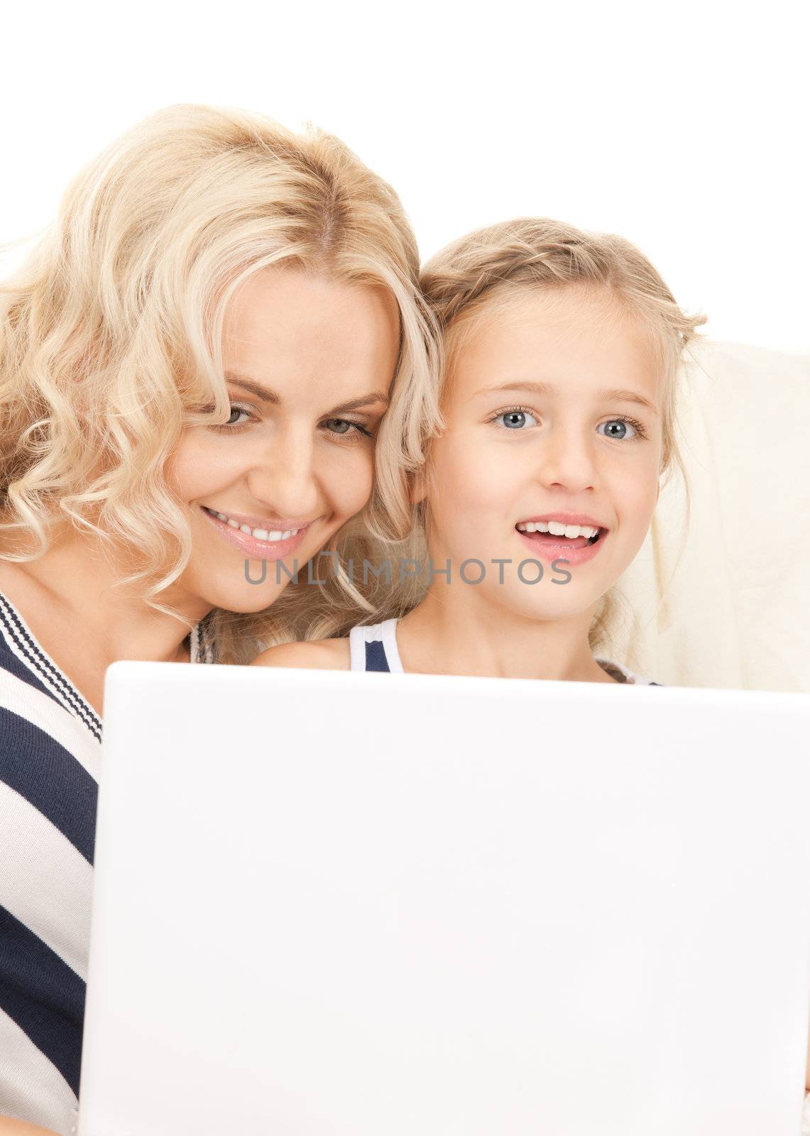 bright picture of happy mother and child with laptop computer (focus on woman)