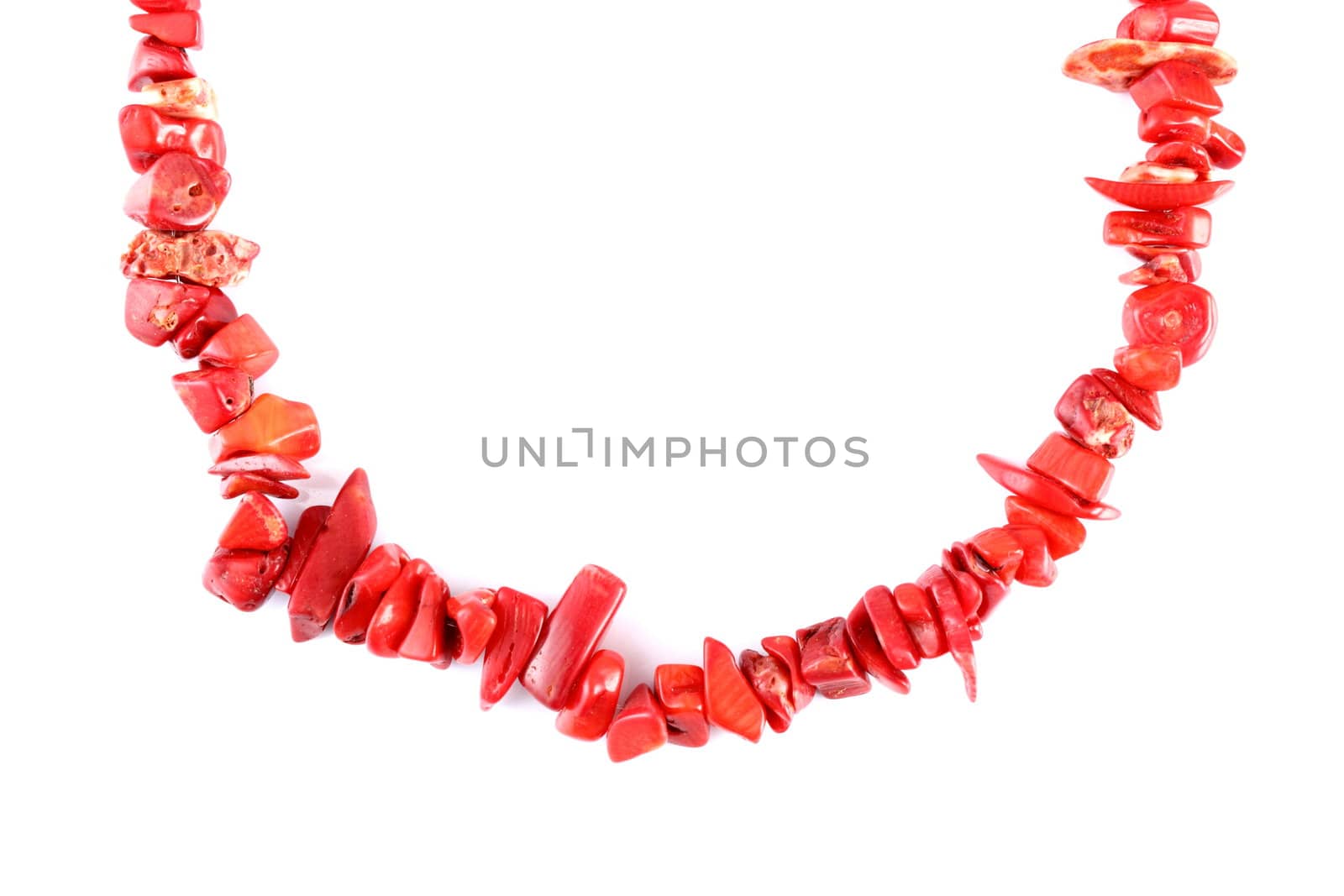 red coral beads over white background