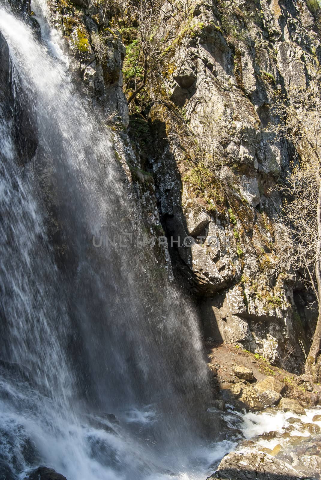 Landscape with vernal waterfall in sunny day