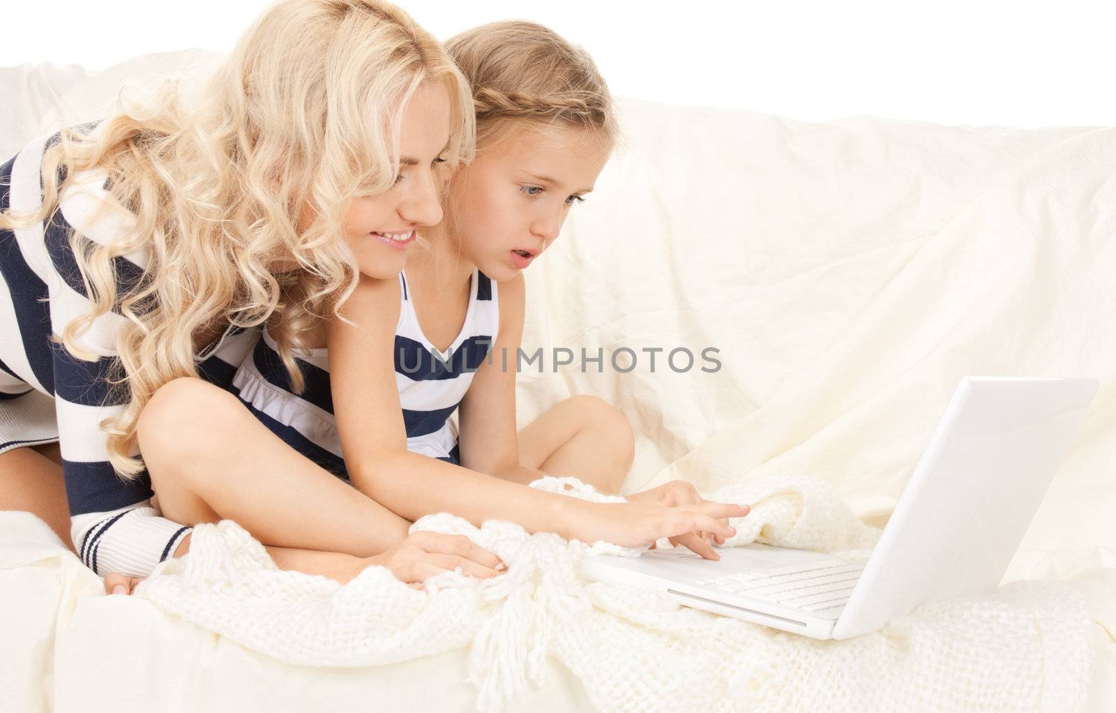 bright picture of happy mother and child with laptop computer