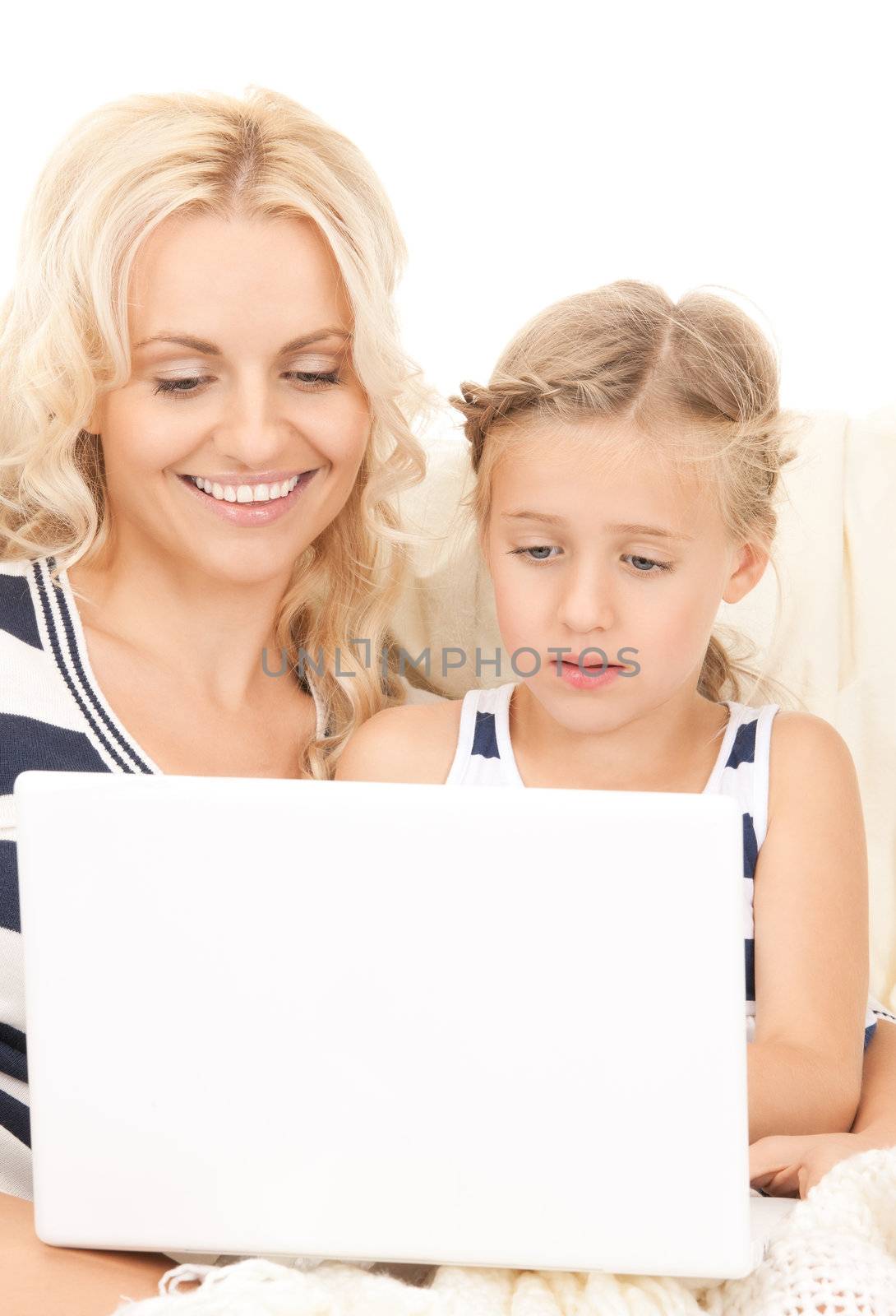 bright picture of happy mother and child with laptop computer